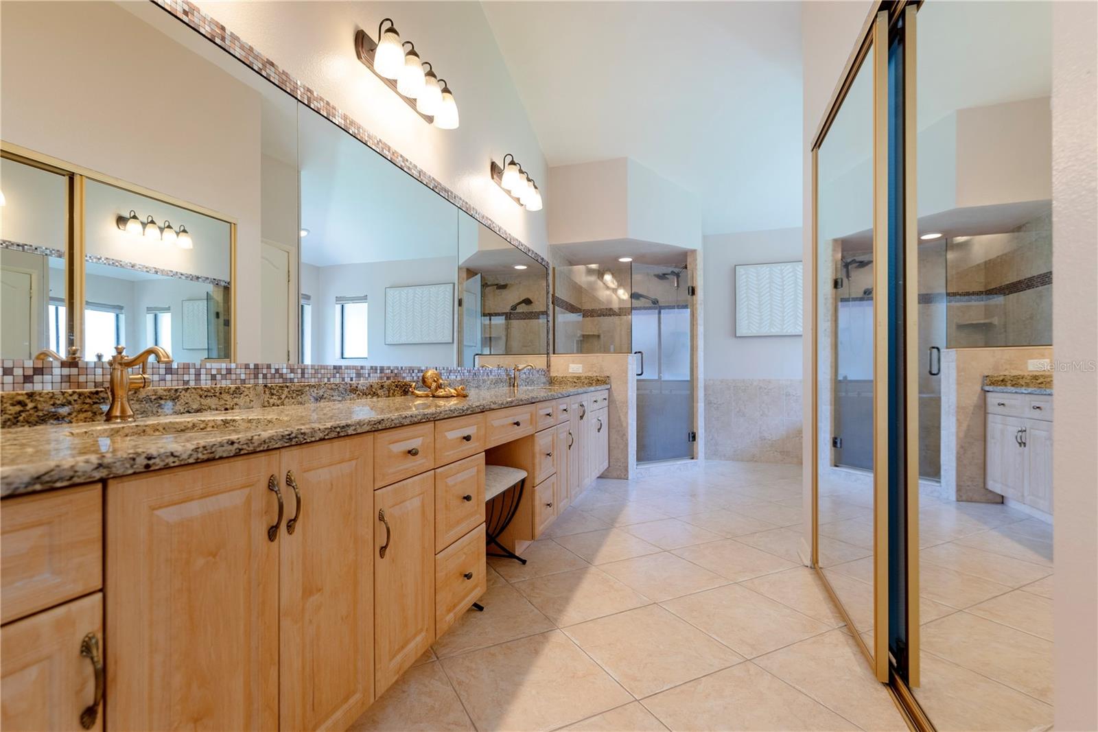 Primary en-suite bathroom with dual sinks.