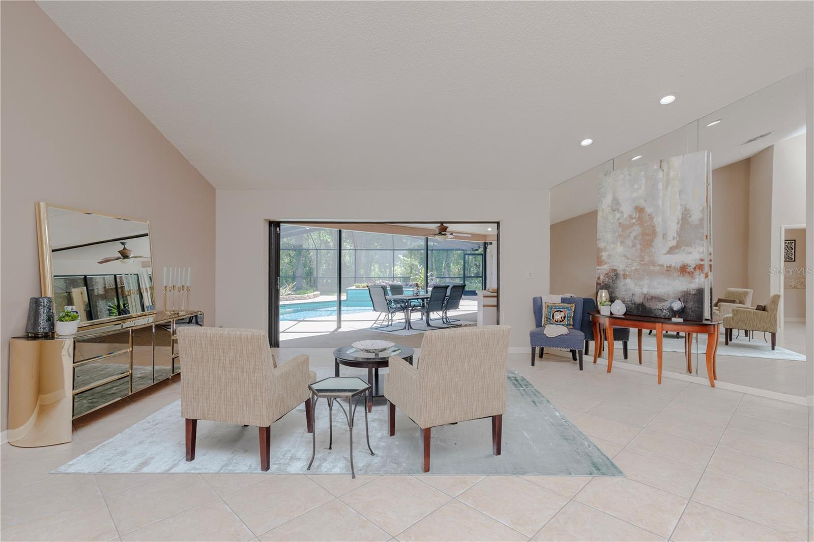 Living room with triple slider to pool lanai.