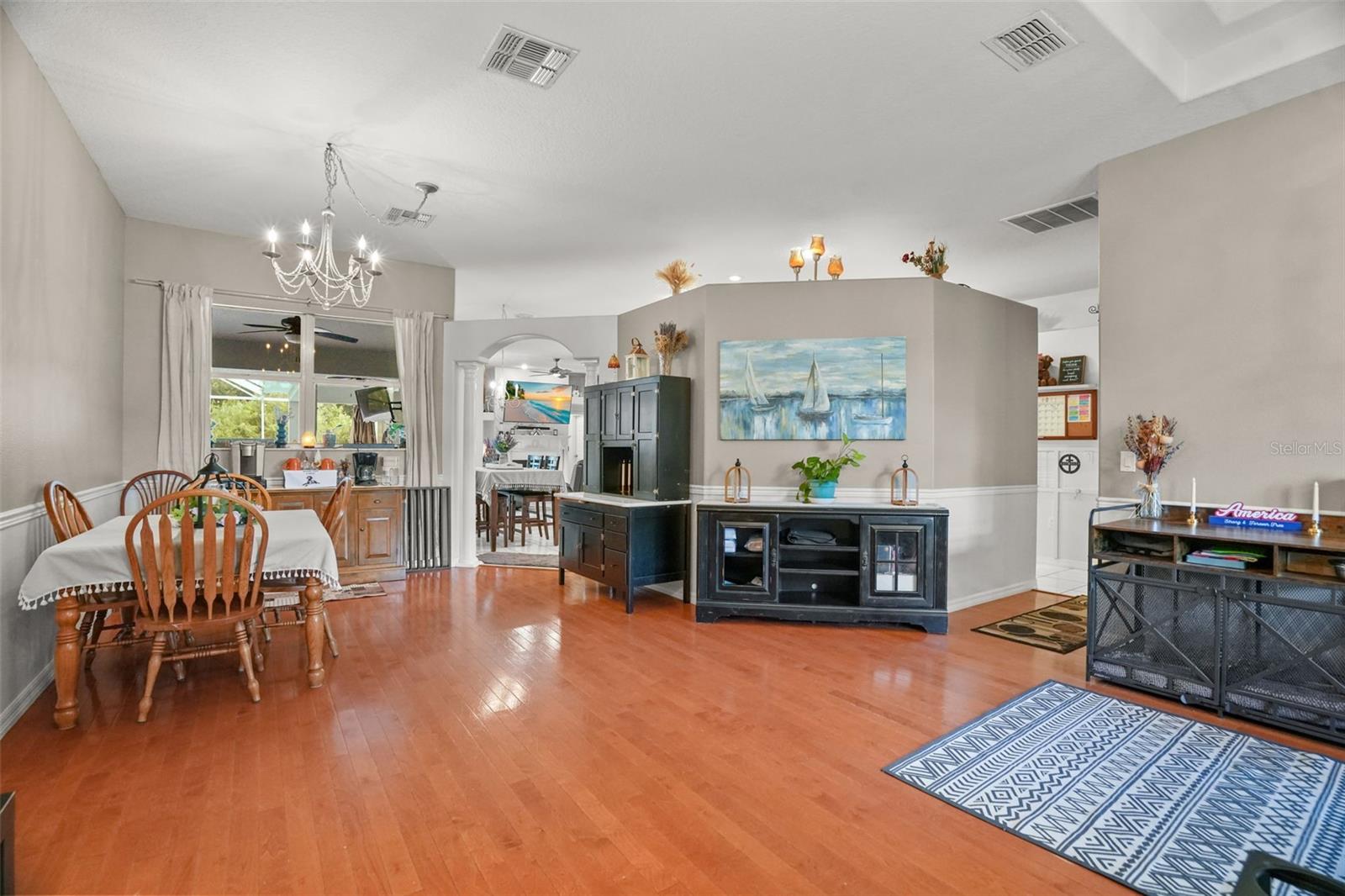 As you enter the home, formal living and dining room with wood flooring