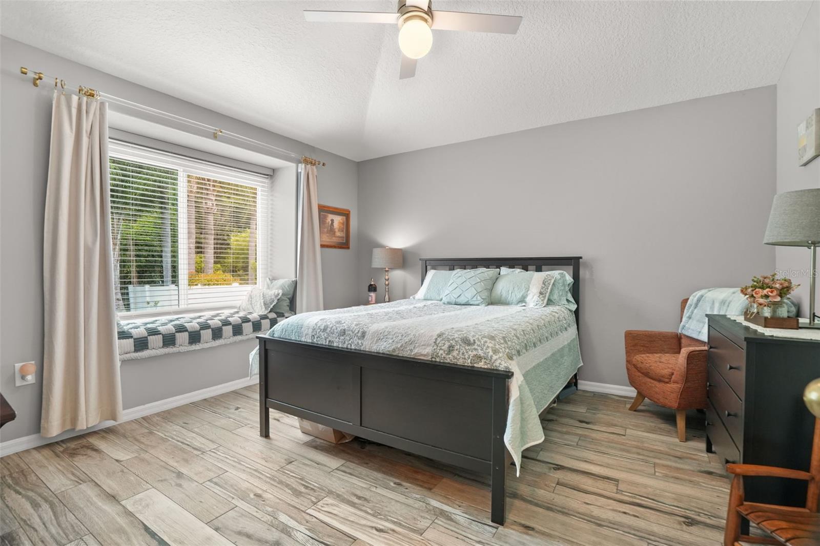 4th bedroom with window seat in the back of the home.