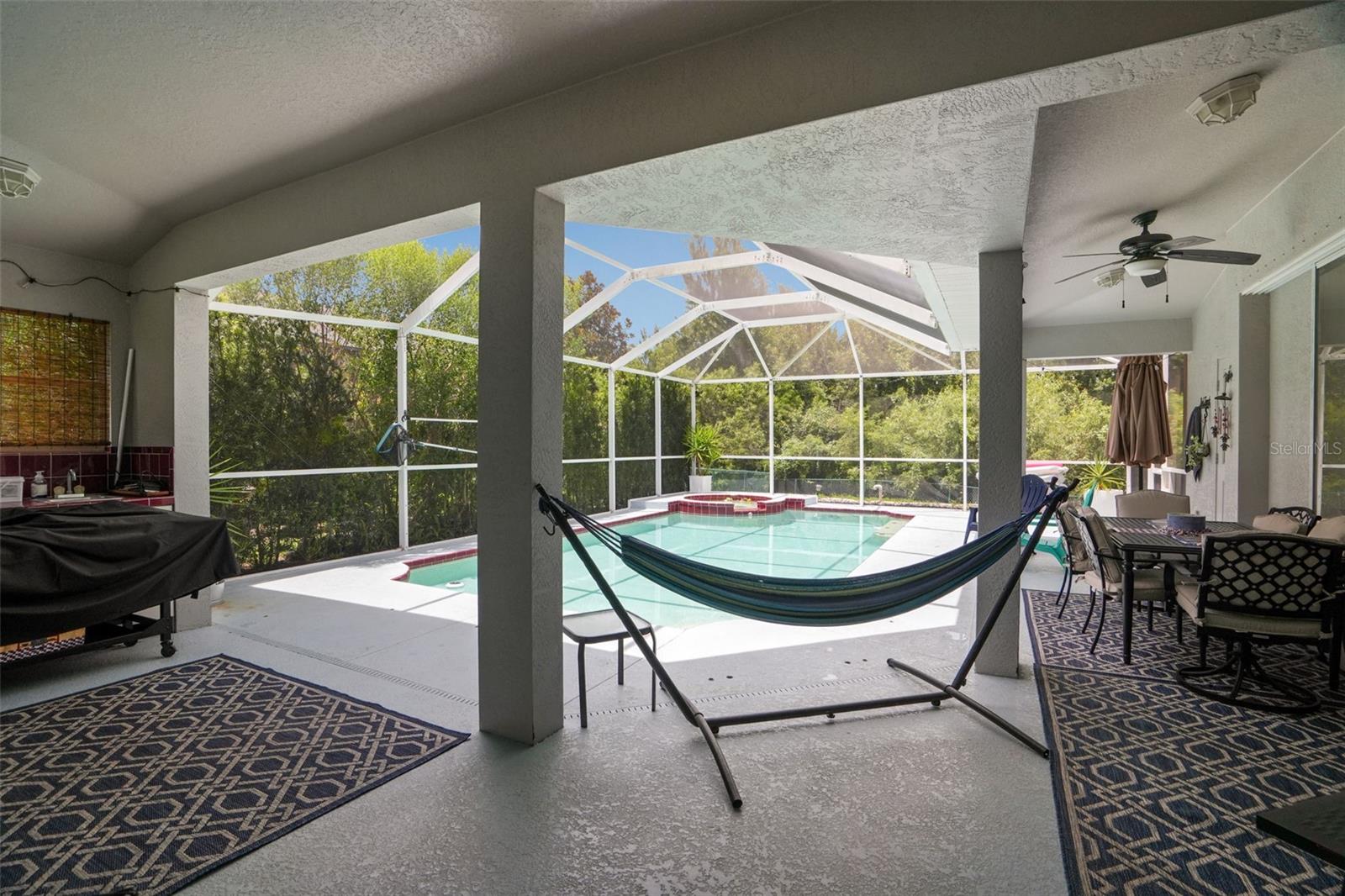 Expansive covering under the screened enclosure