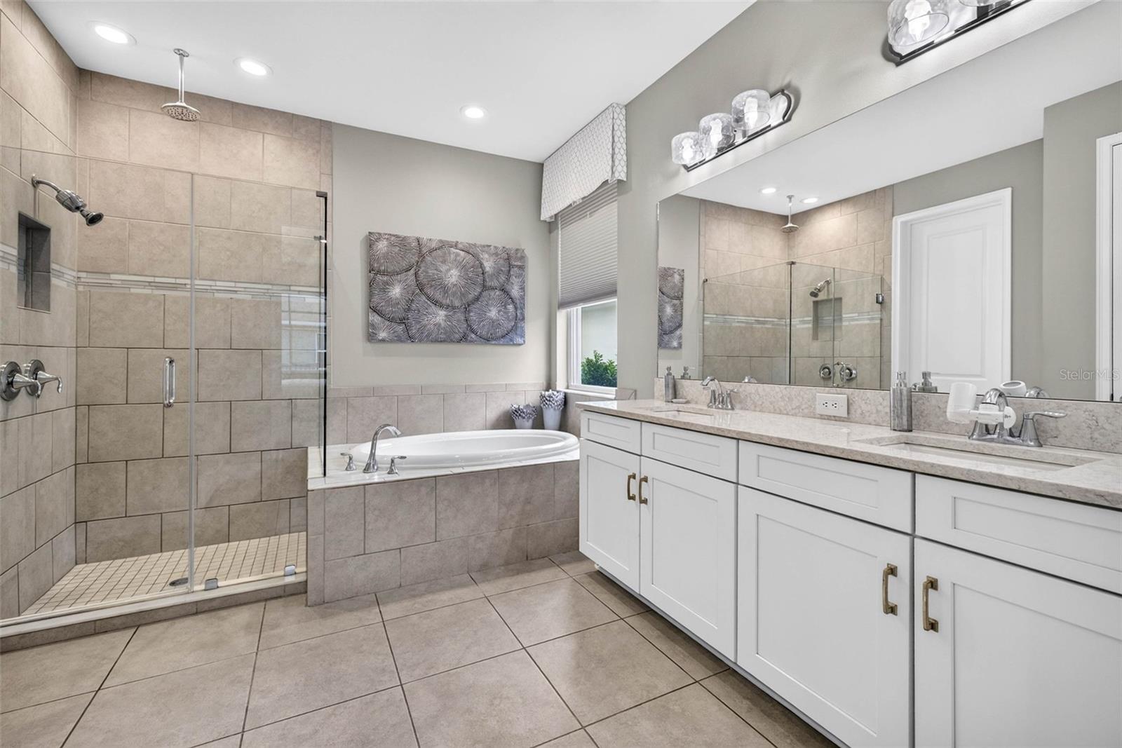 First floor primary ensuite bath with tub and shower.