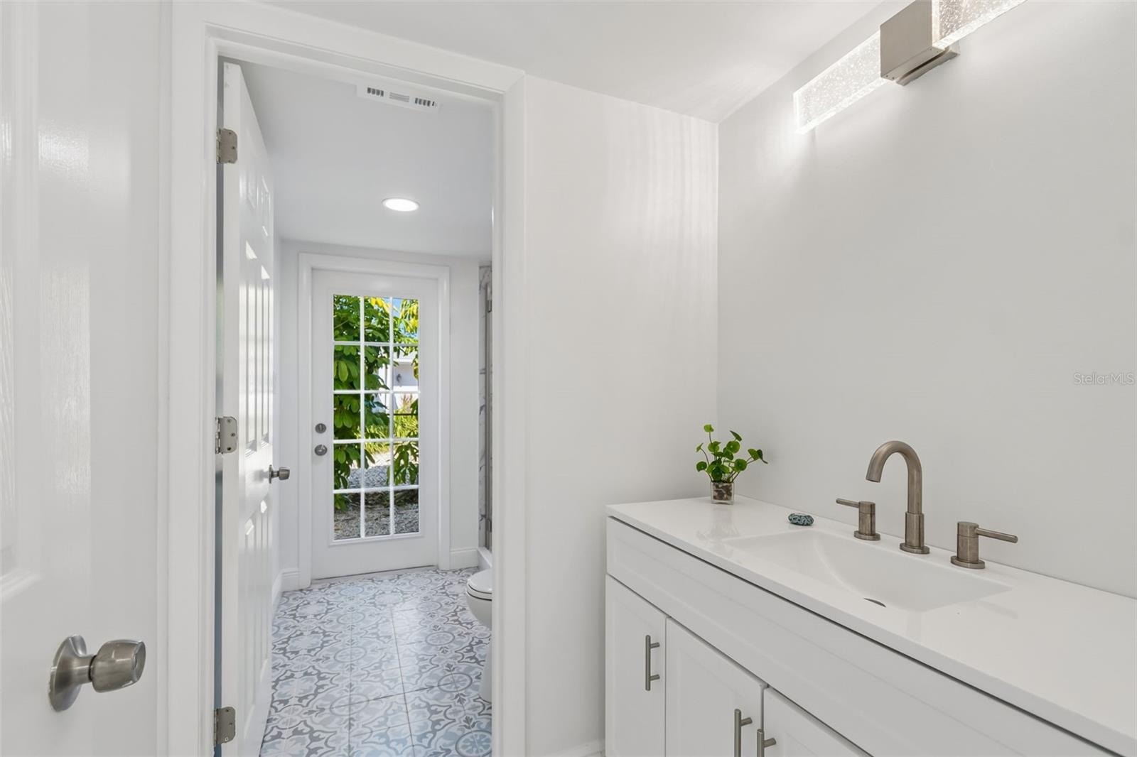 Ensuite bathroom with separate toilet and shower leading outside