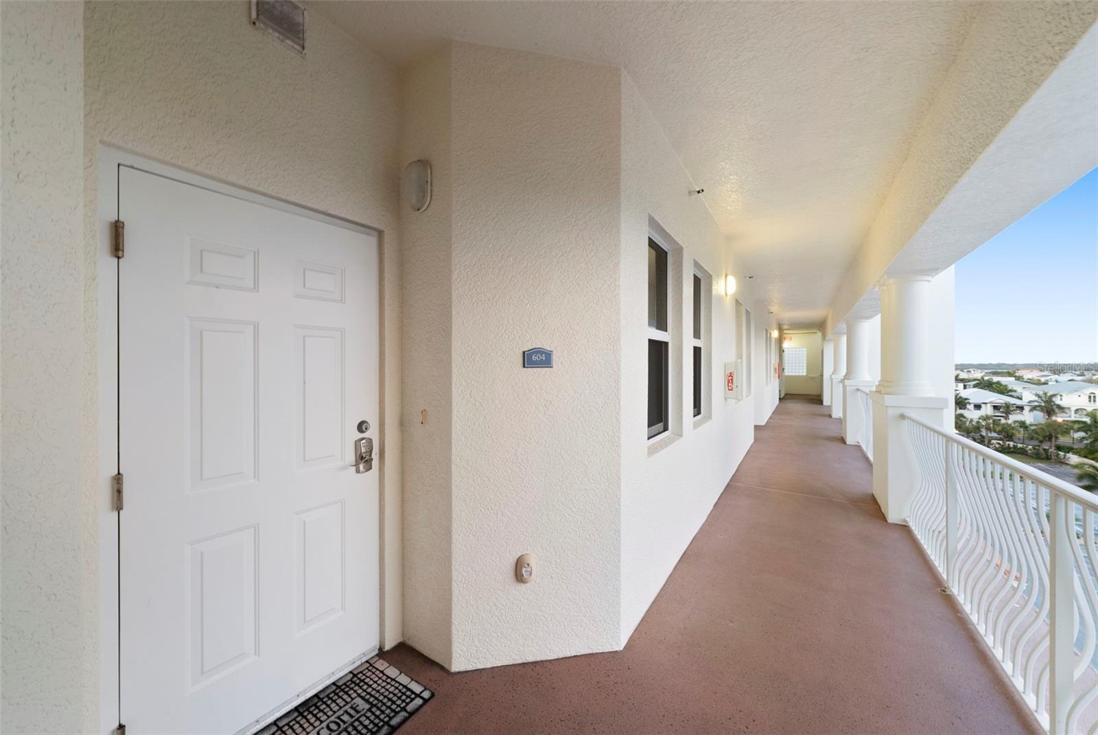Front door entry, views of community parking and adjacent waterfront homes