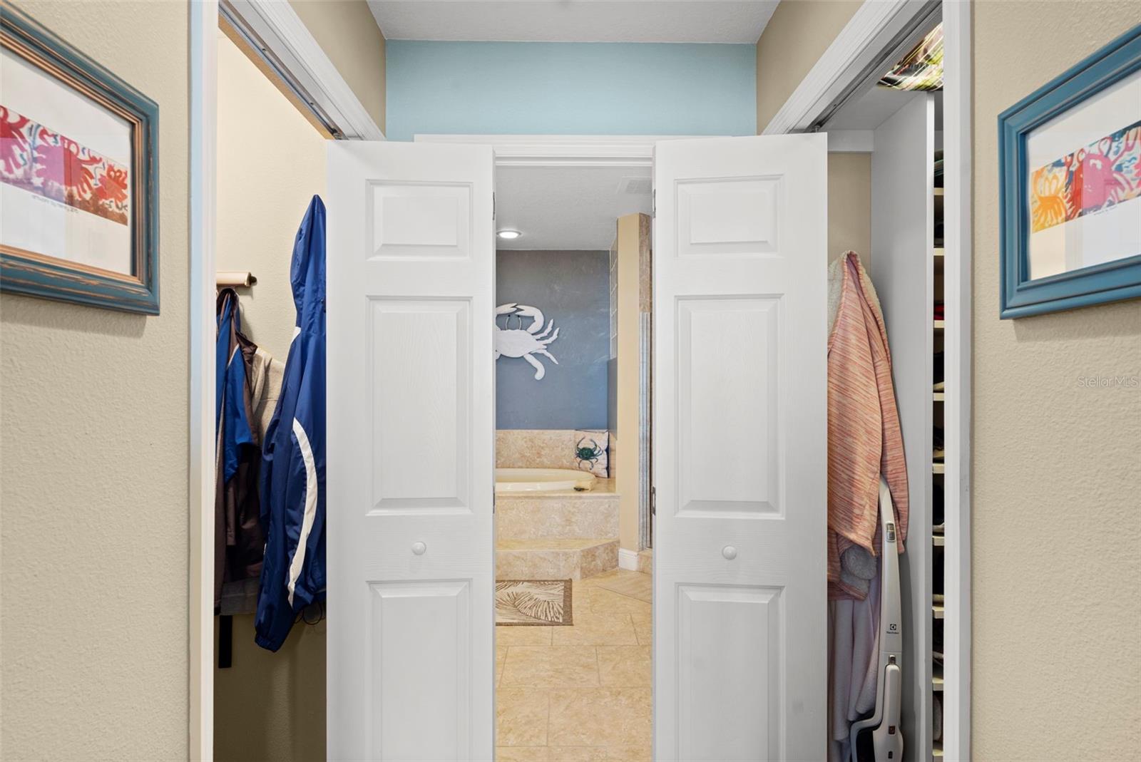 Primary en-suite closet to bathroom entry hall