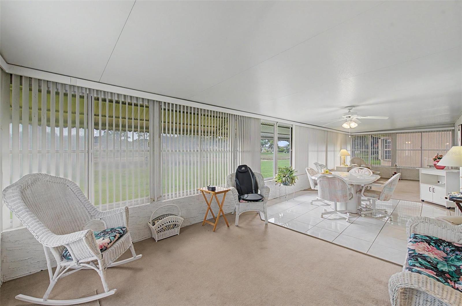 Enclosed Florida Room looks out at pond.