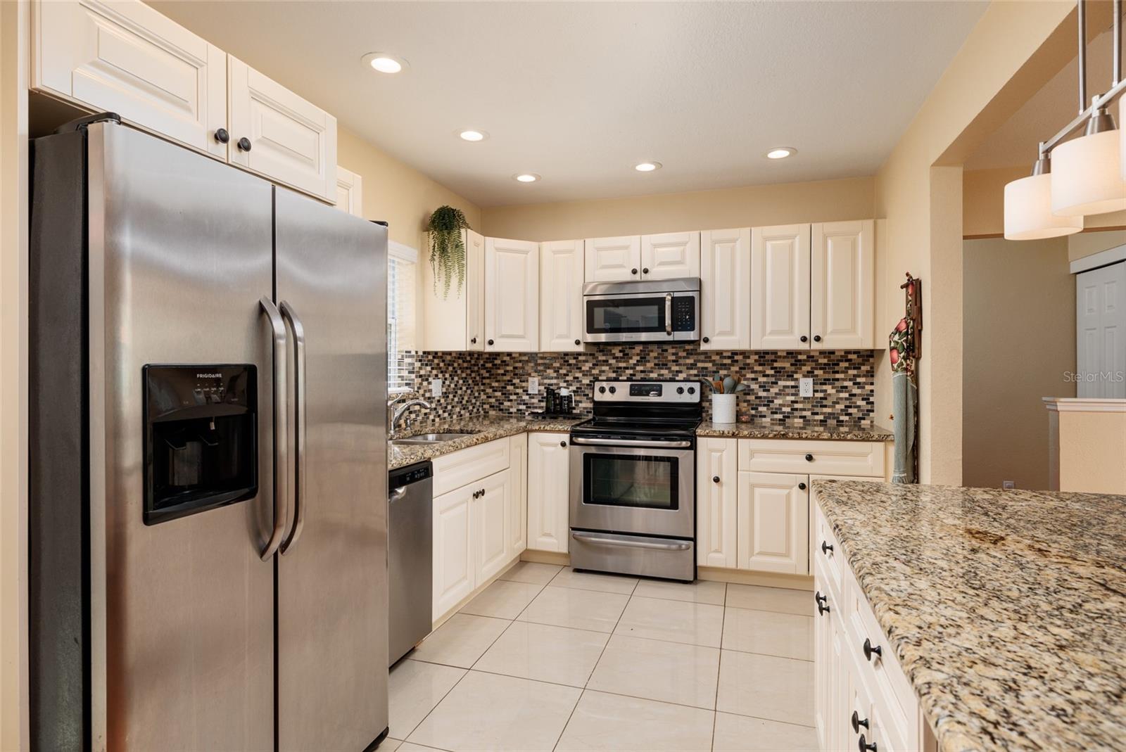 Stainless appliances, granite countertops, soft white cabinets and updated lighting throughout.