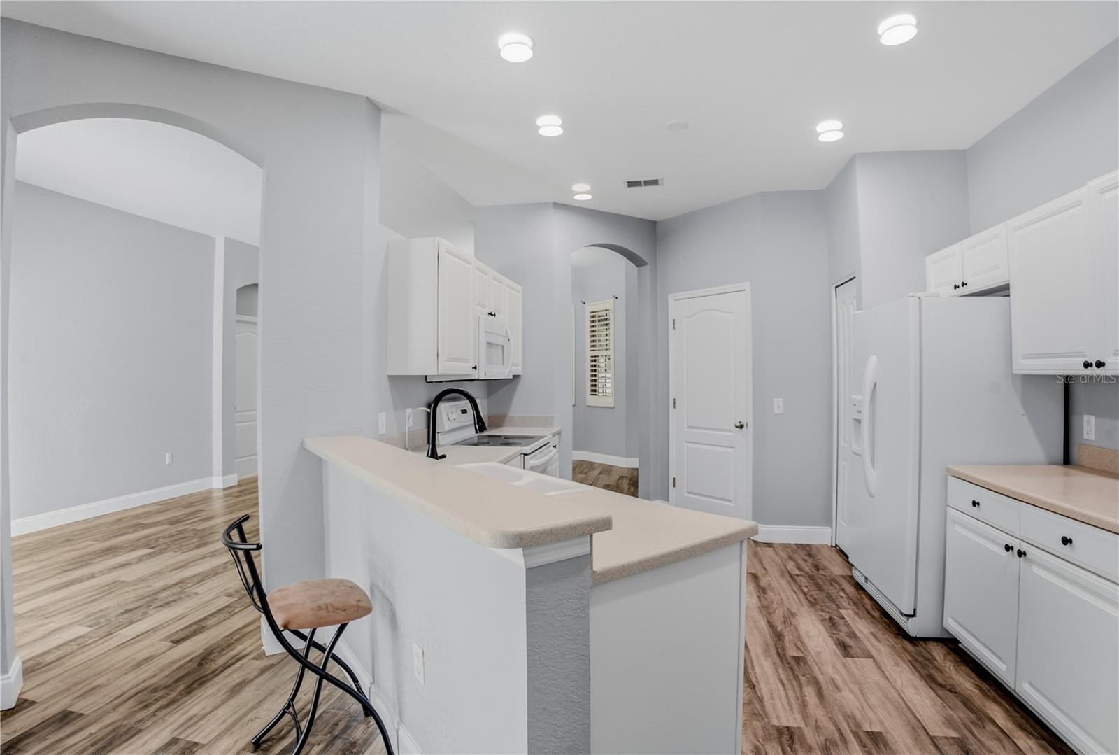 KITCHENWITH WALK THROUGH TO DINING AREA AND LIVING ROOM ENTRANCE TO LEFT