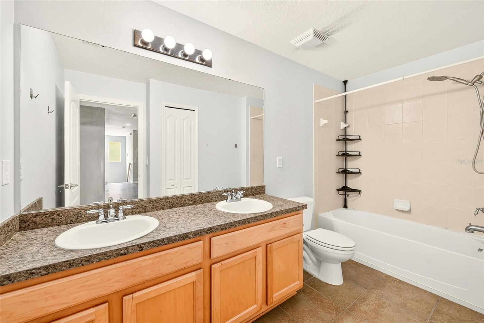 Upstairs bathroom featuring a dual sink vanity