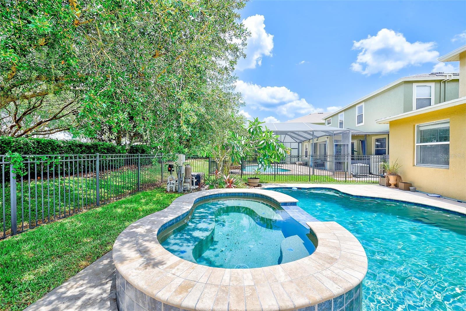 Oversized hot tub featuring power water jets, foot bubbler, water fall spillover and gas heater.