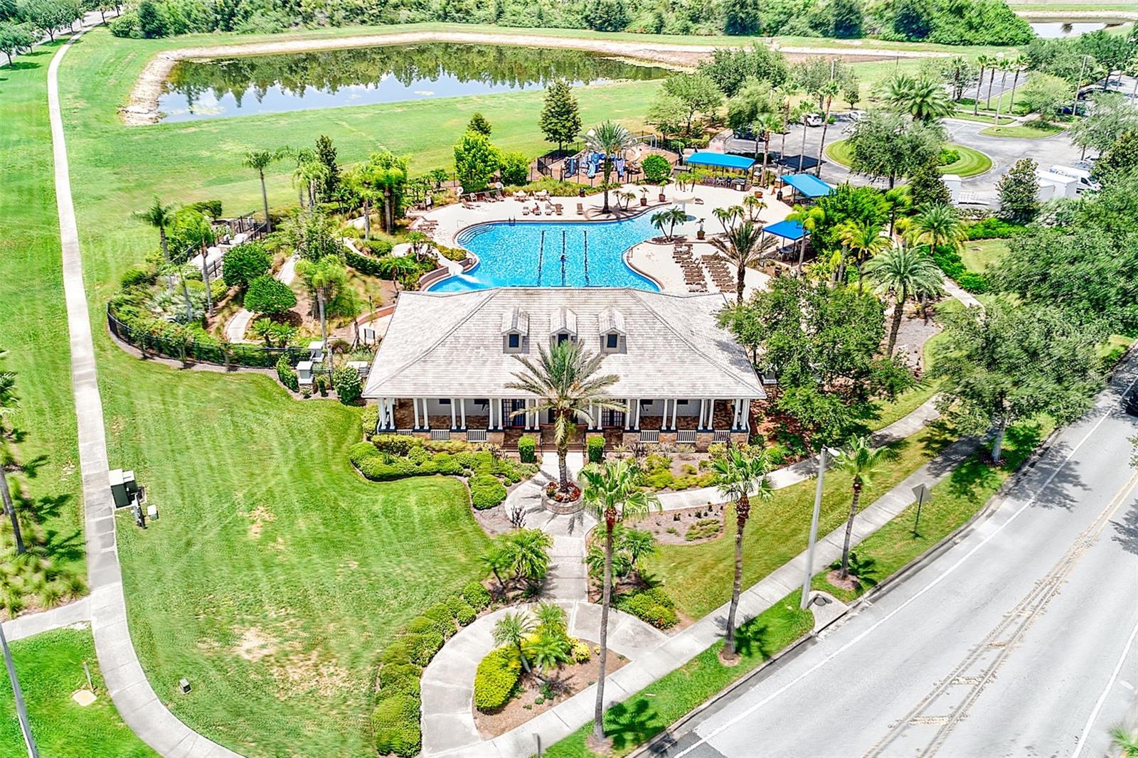 Community Center featuring a resort style pool with a beach entry, mushroom water fall and slide as well as a gym, playground, basketball court, soccer field and cricket field