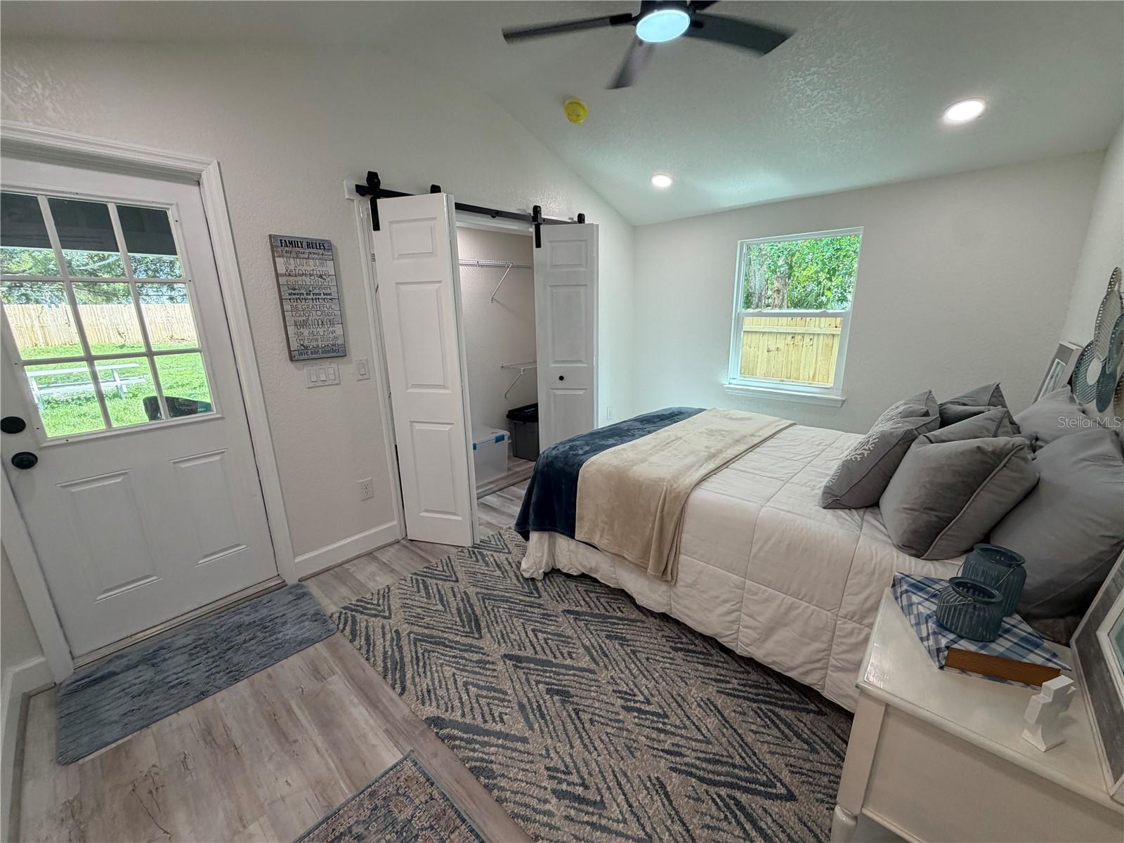 Primary bedroom with folding barn doors to the large closet