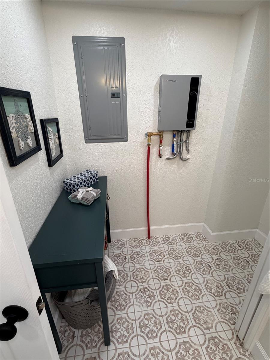Tankless water heater, new electric panel, an area for your stackable washer and dryer to the right