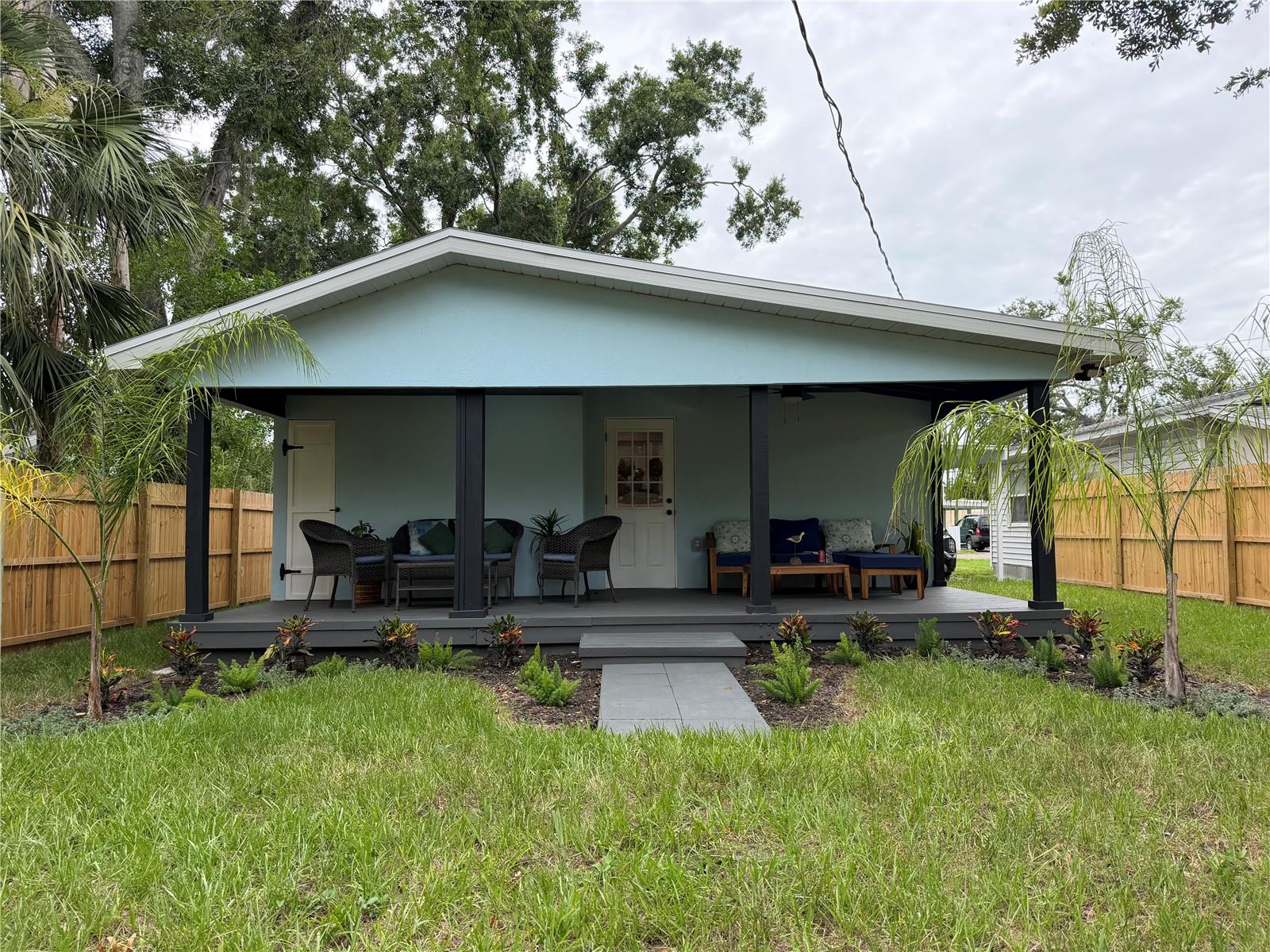 Rear porch, with composite wood decking, high ceilings, fans, and lights. A great place for entertaining.