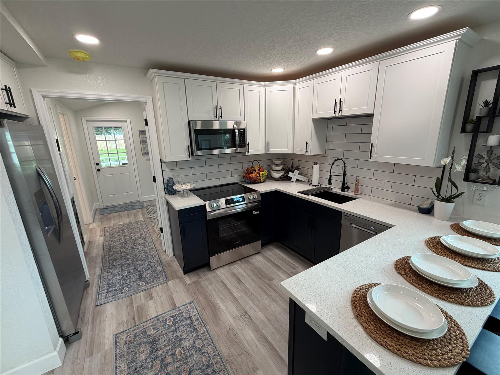 Wood cabinetry… quartz countertops, stainless appliances,