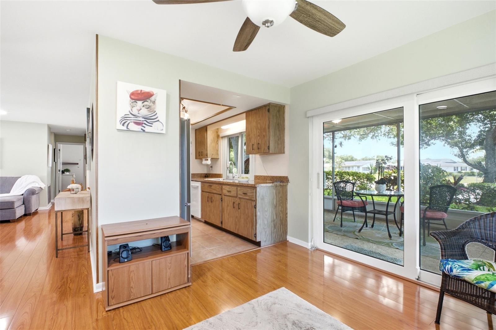 Large hurricane-impact glass sliders lead to the screened lanai~
