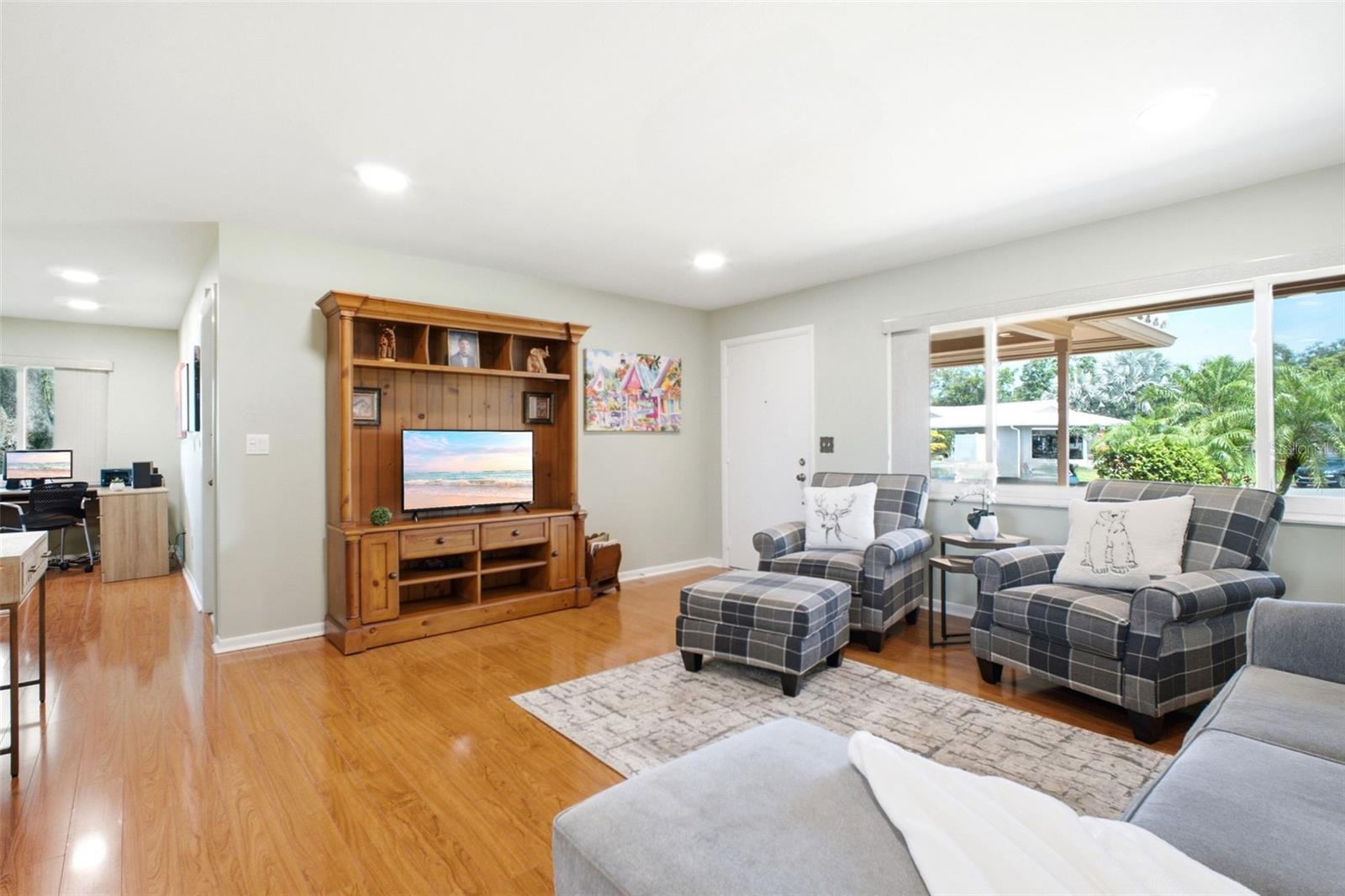 The oversized hurricane-impact windows allow natural light to flood the space~