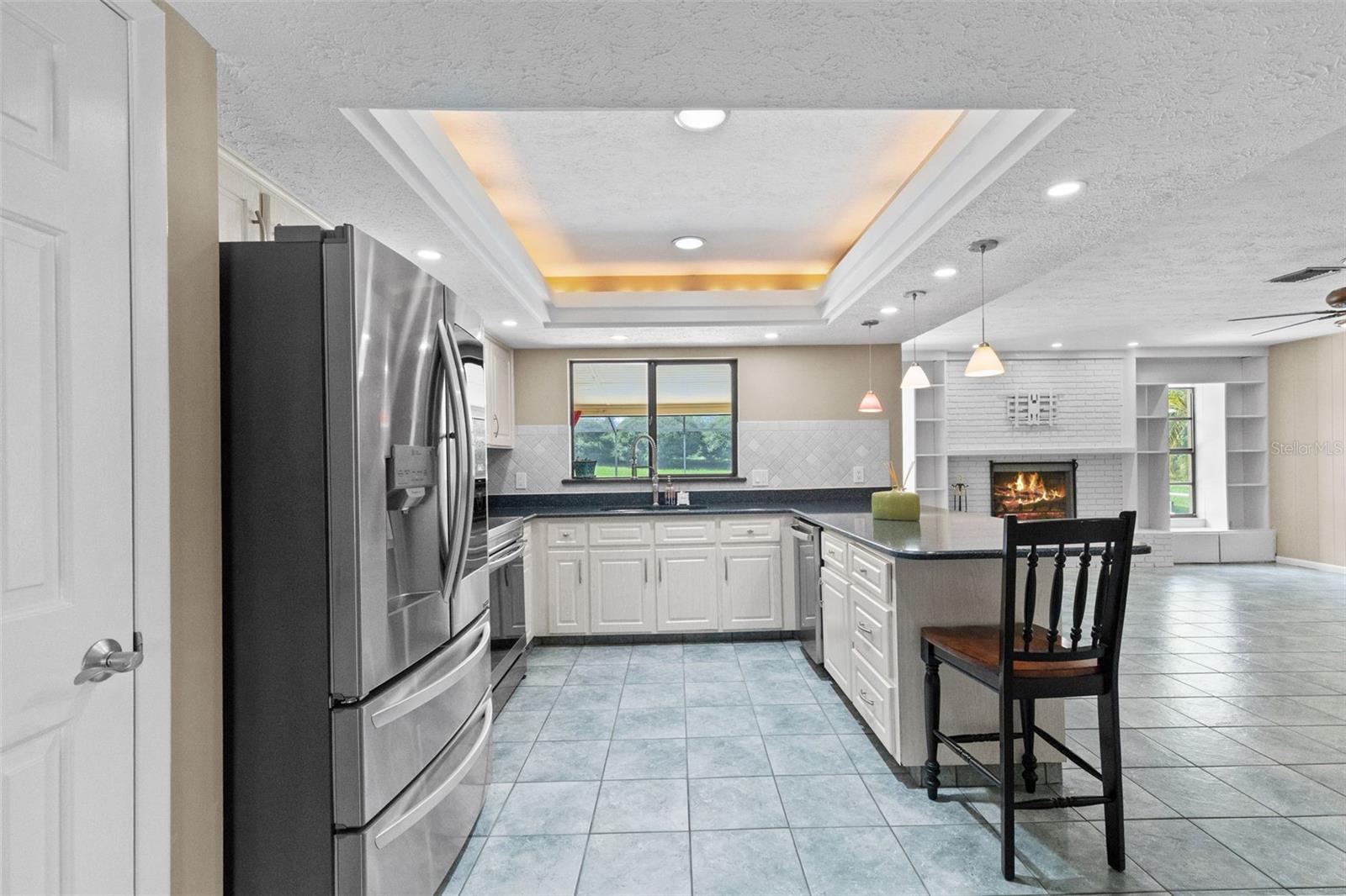 Kitchen with window over the sink to the lanai and pool. Note stainless appliances.