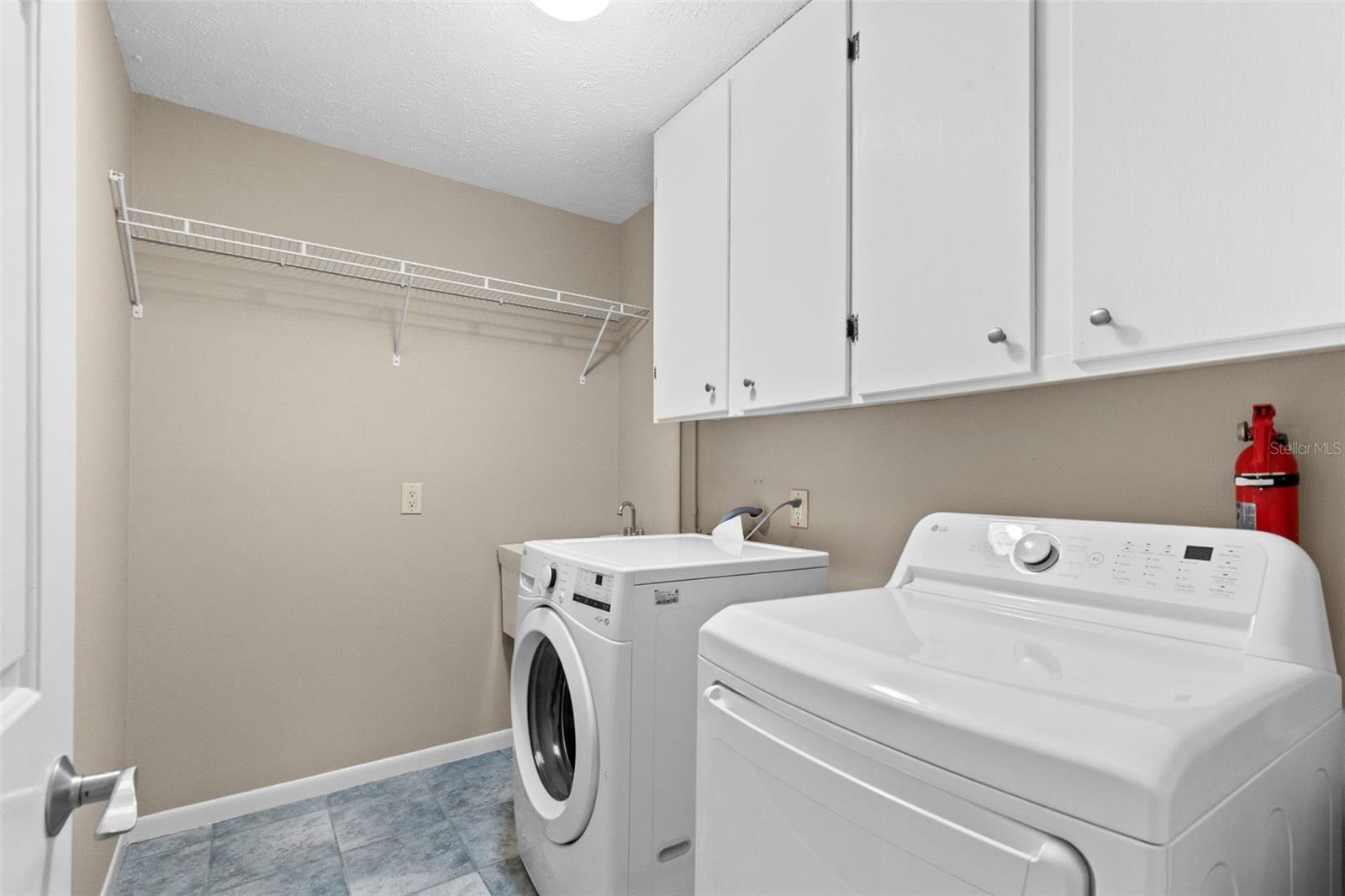 Laundry room with lots of shelving.