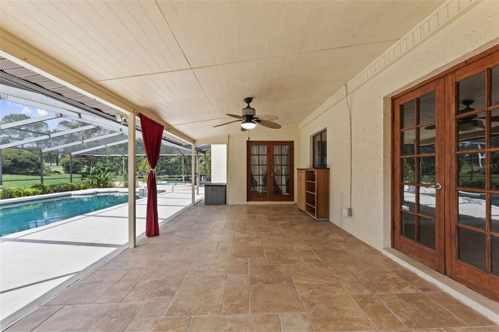 2 sets of French doors open to the screened lanai with easy care tile flooring.
