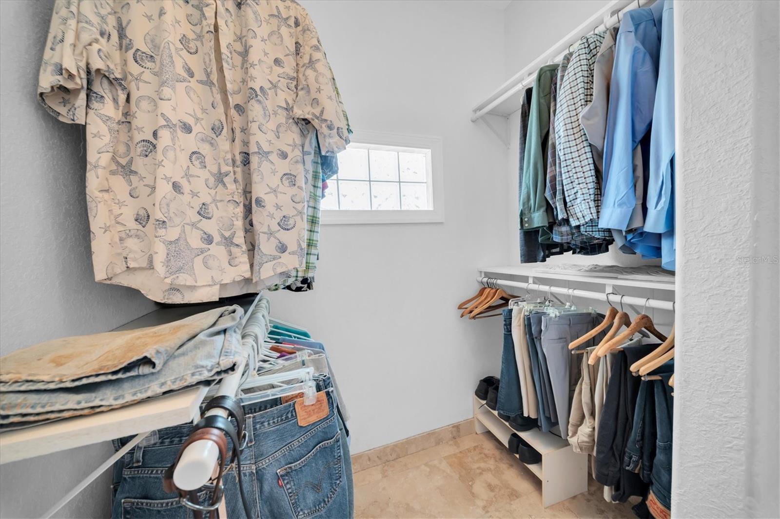 One side of Primary walk in closet