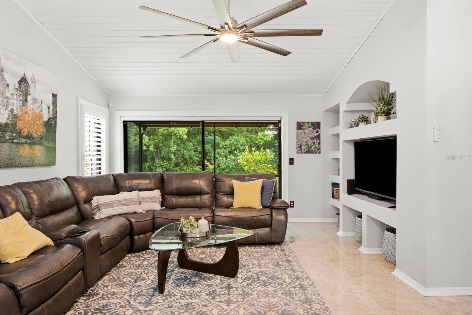 Well sized family room, built-ins surround the tv, gorgeous paneling