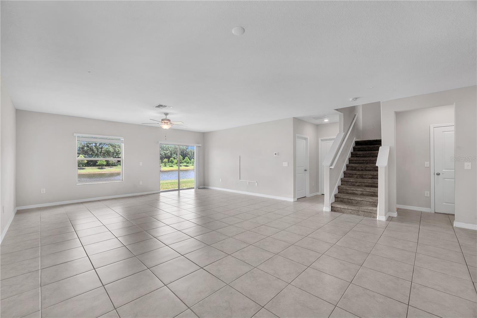 The first floor primary entrance and laundry room is to the left of the staircase and a convenient half bath and garage access is to the right of the staircase.