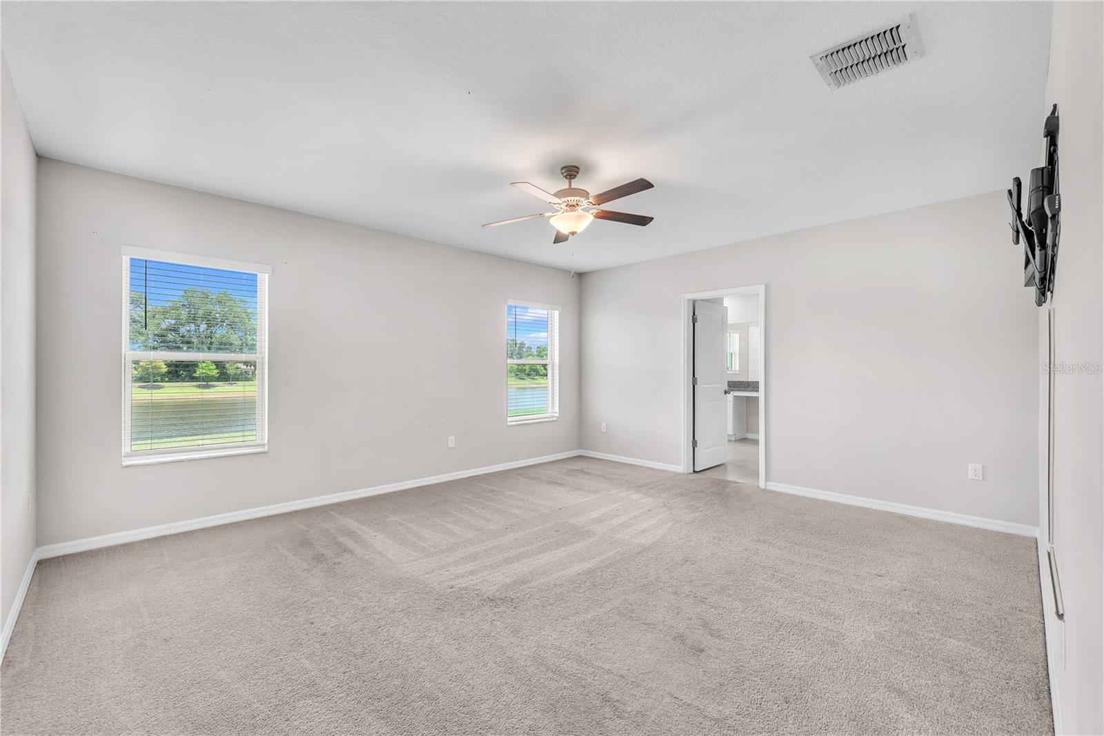 Tucked away at the rear of the home for added privacy, the spacious first-floor owner's suite serves as a peaceful retreat with a large walk-in closet and a private en-suite bathroom designed for comfort and convenience.