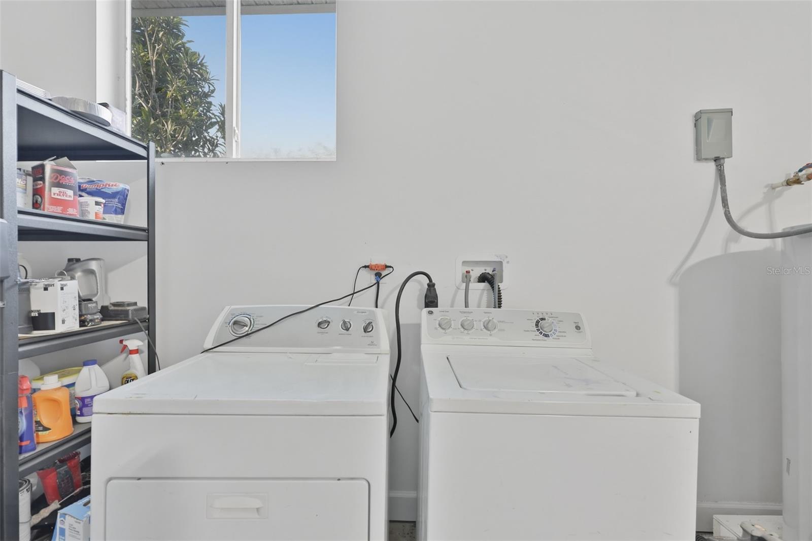 In garage, washer and dryer convey