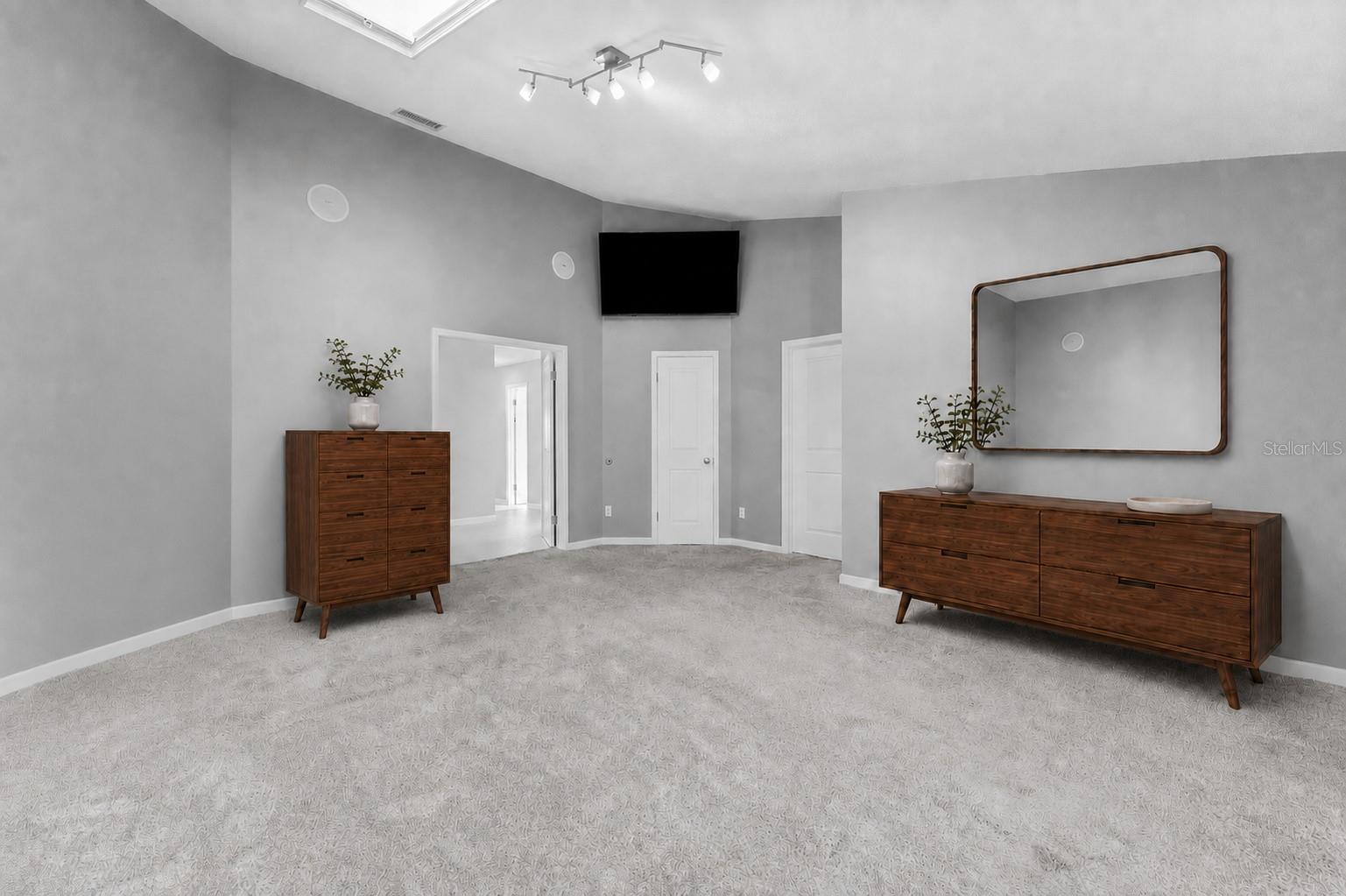 Primary suite with doors to hallway, walk in closet and en-suite bathroom
