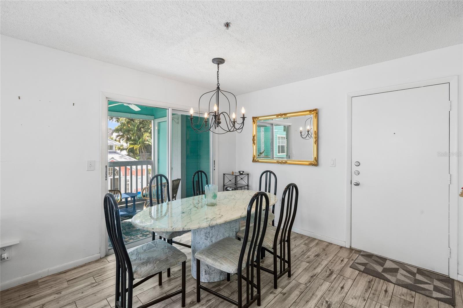 Dining room overlooking balcony & pool area