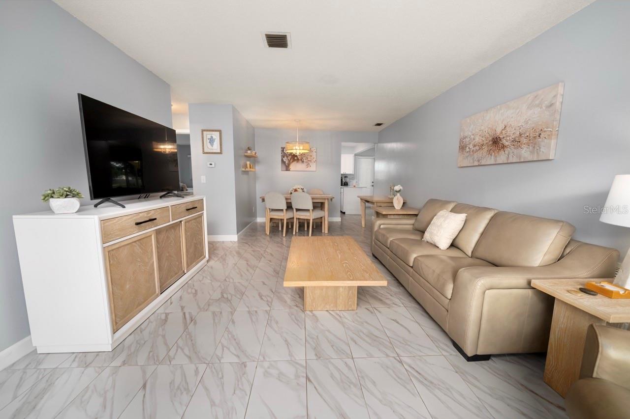 FAMILY ROOM. THIS VILLA STYLE CONDO IS PERFECT FOR ENTERTAINING FAMILY AND FRIENDS