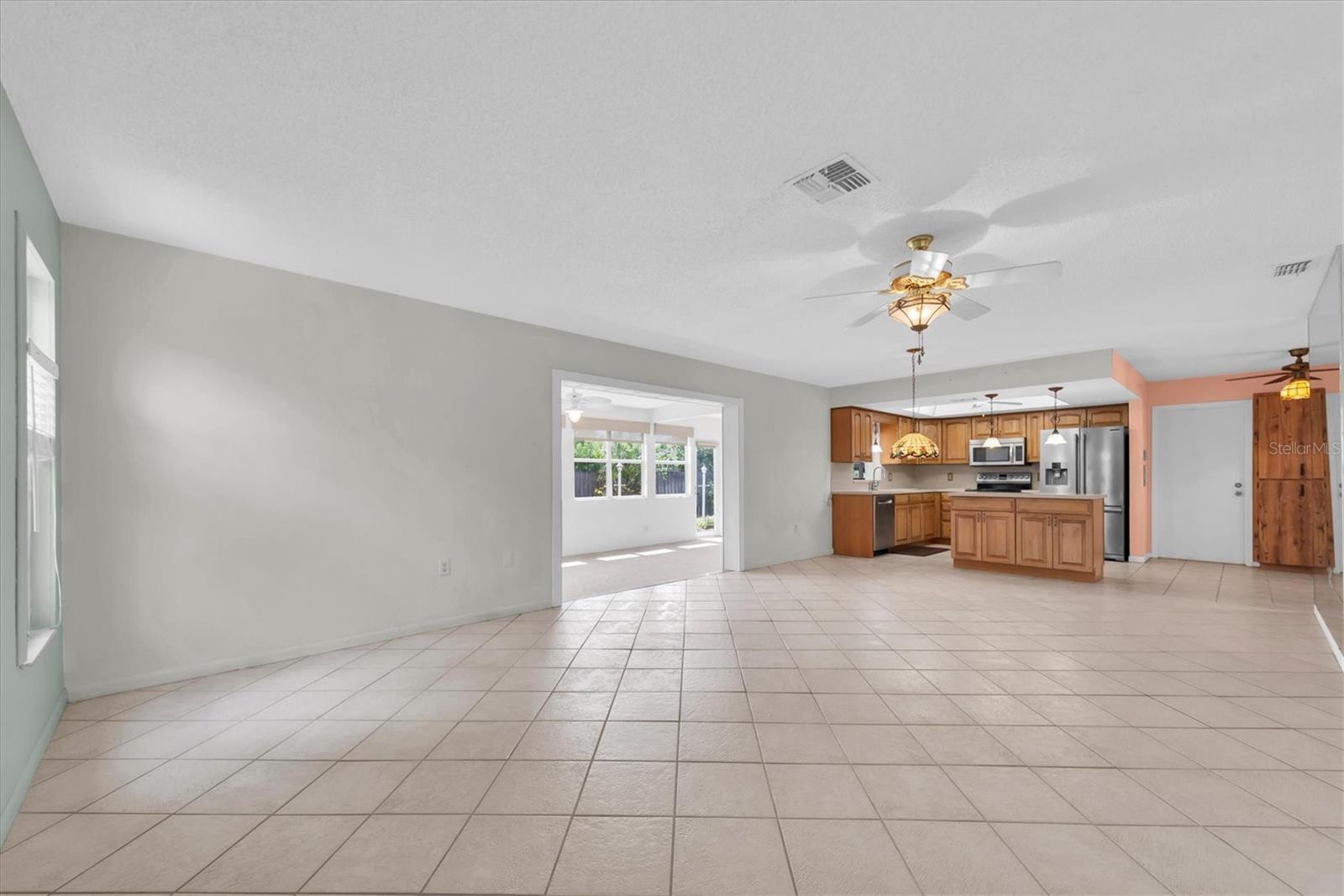 Open Floor Plan - Living, Dining and Kitchen leading to Florida Room