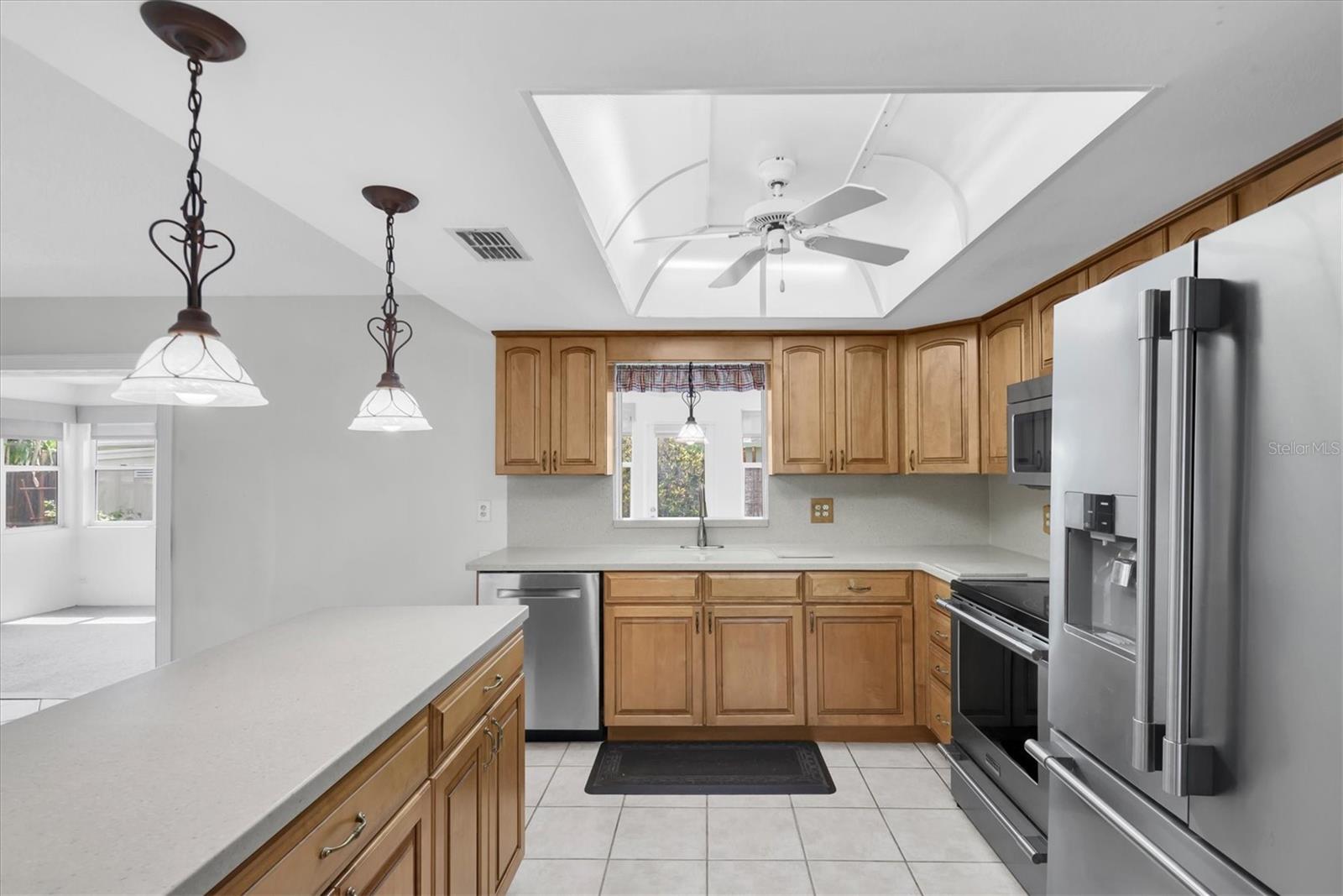 Kitchen with Corian countertops, wood cabinets, and Stainless Appliances