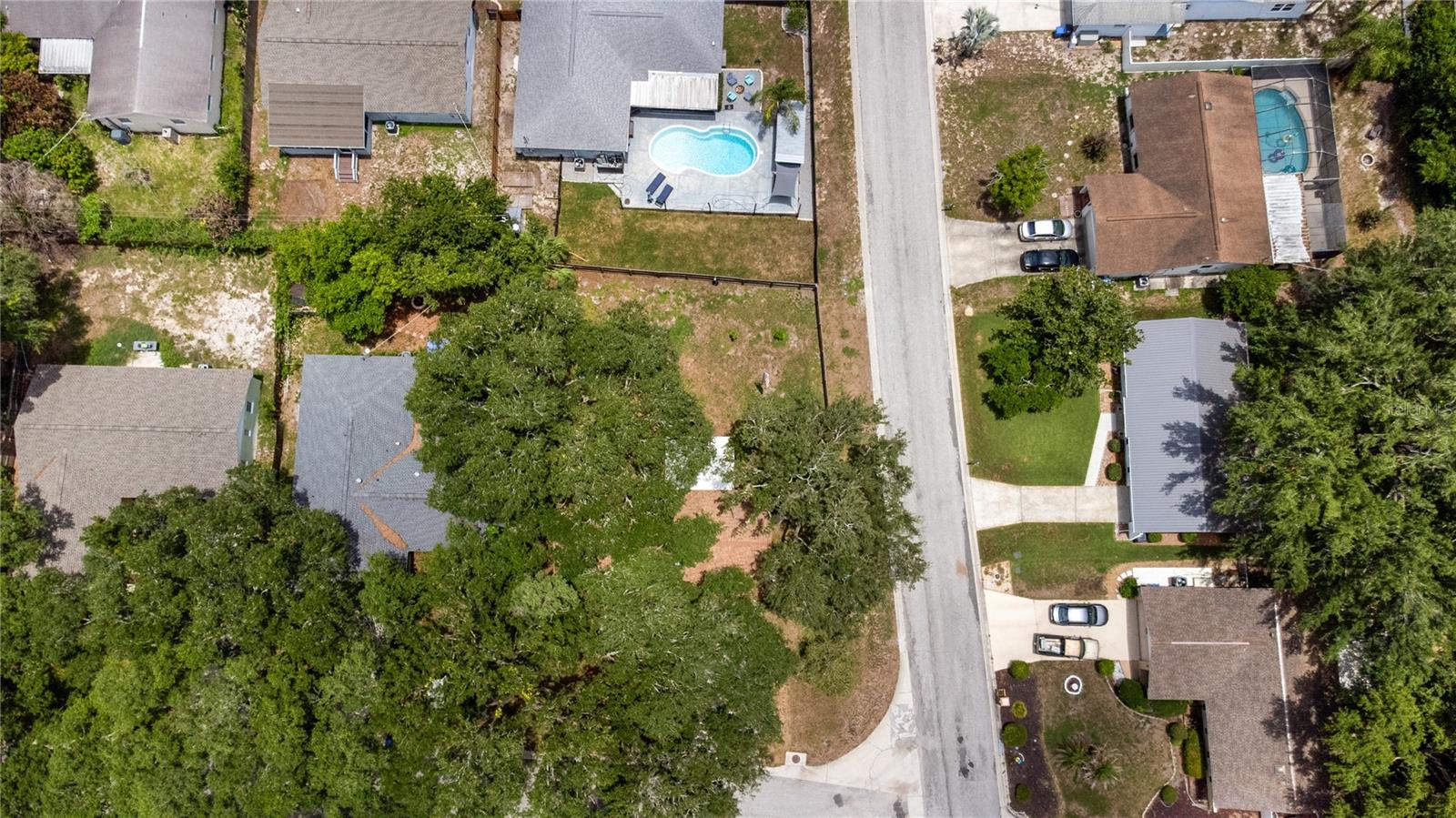 Mature trees encompass the home, protecting from the sun