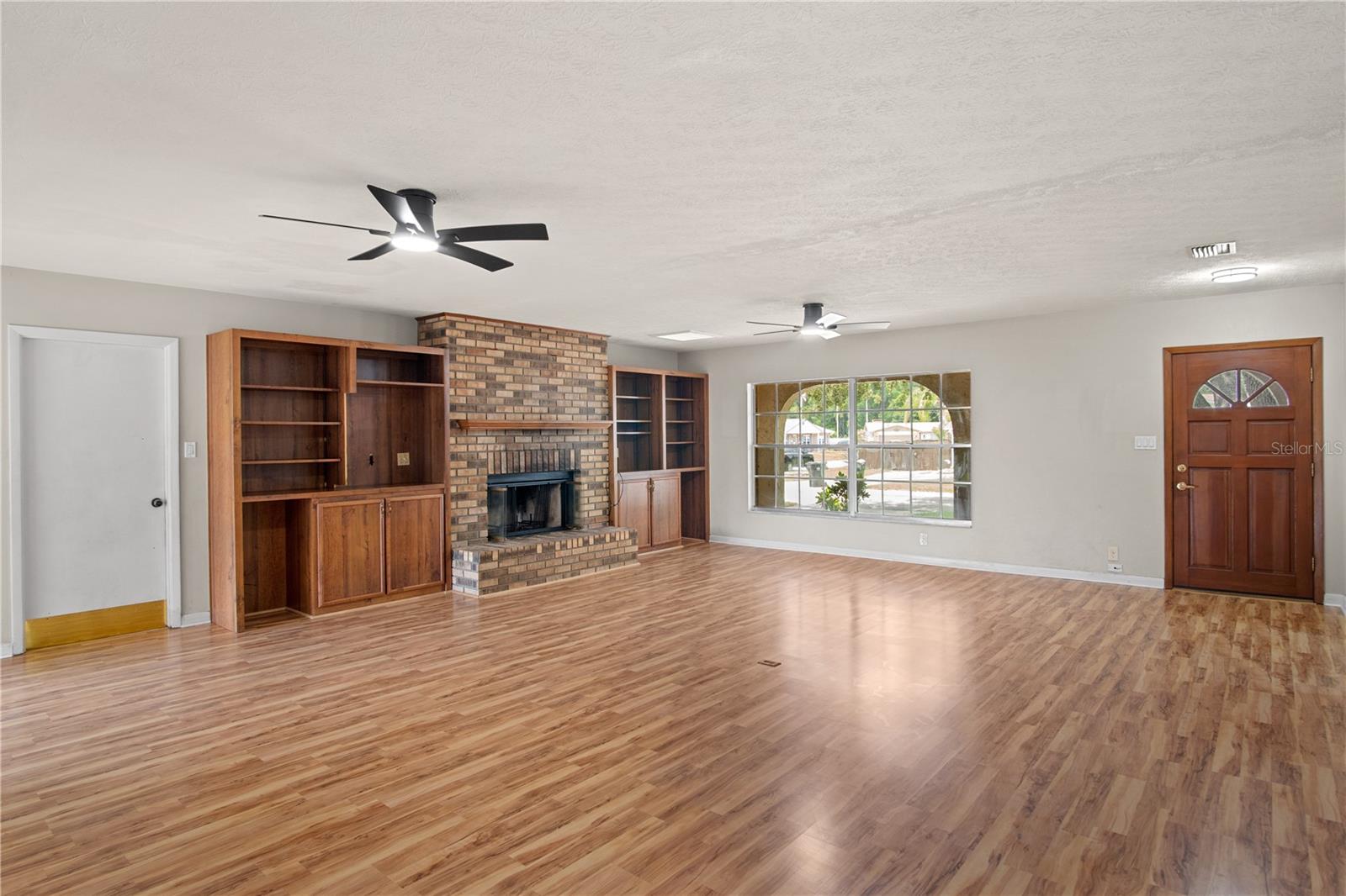 Built in bookshelves around fireplace with access to garage