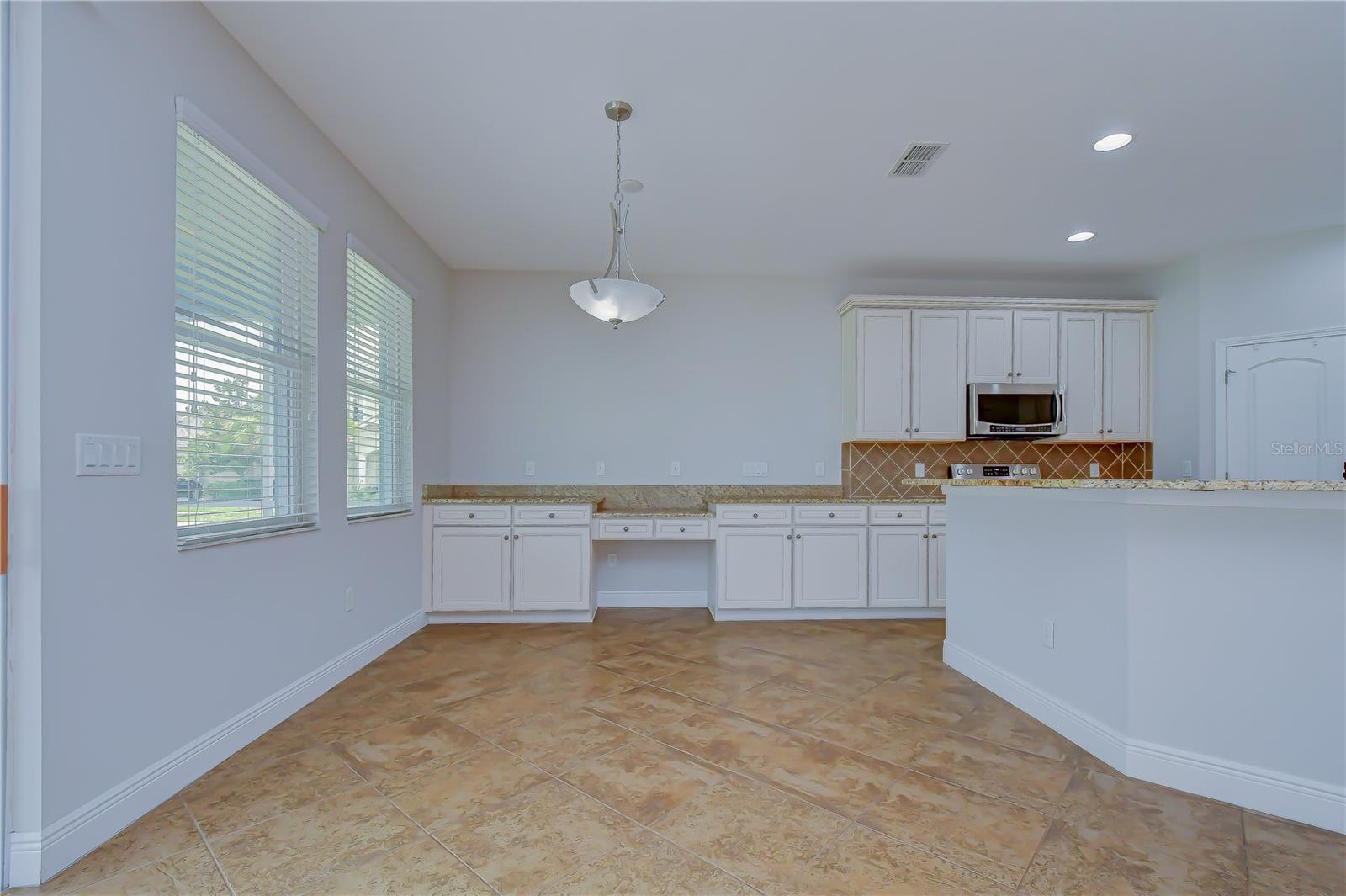 Sunny dining area with additional built-in cabinetry.