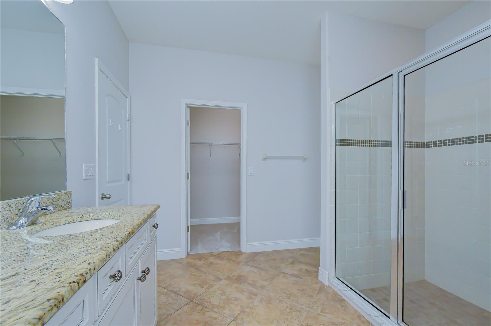 Large walk-in shower and dual sinks with makeup vanity!