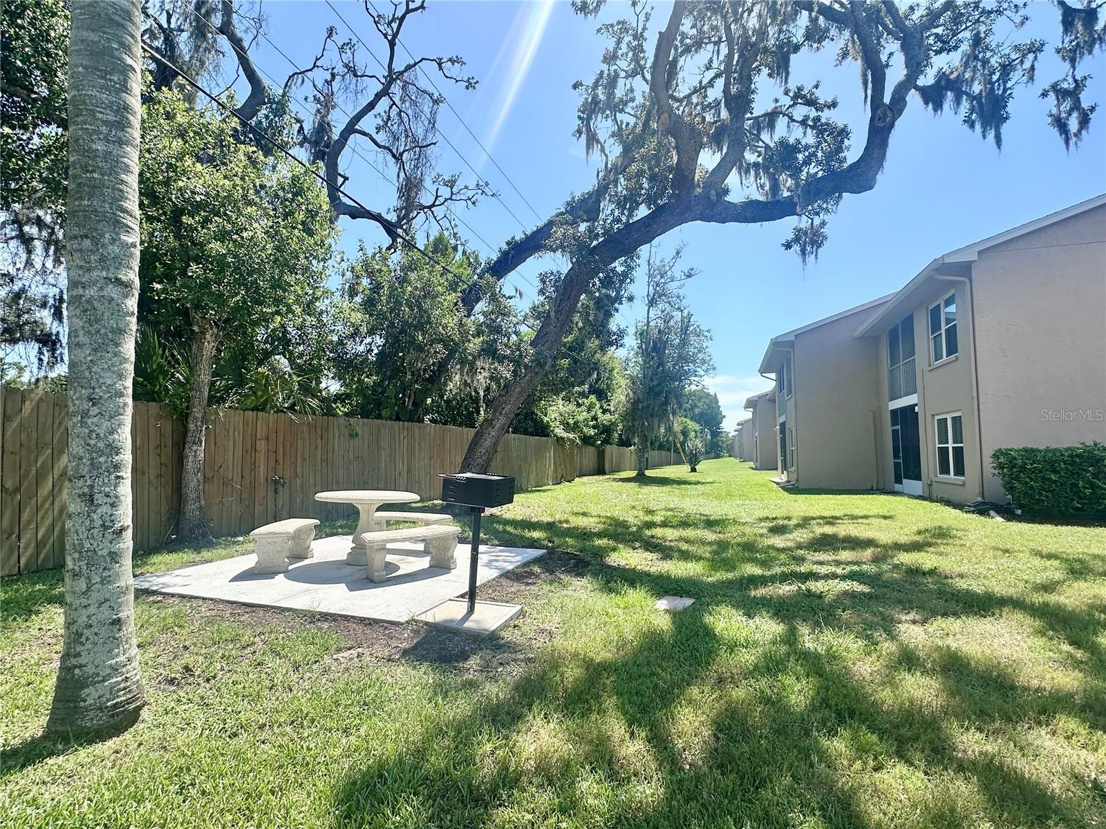 Shared Barbeque & Picnic Table at Corner Back of Condo