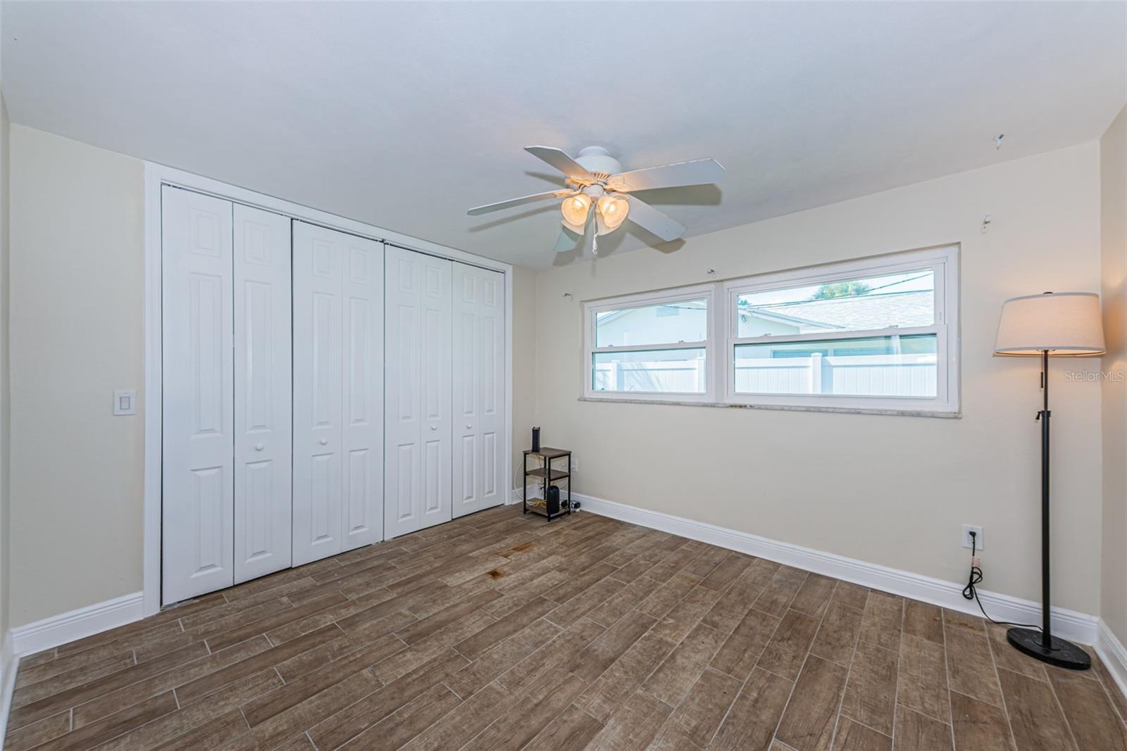 Bedroom 2 has pretty wood-look porcelain tile