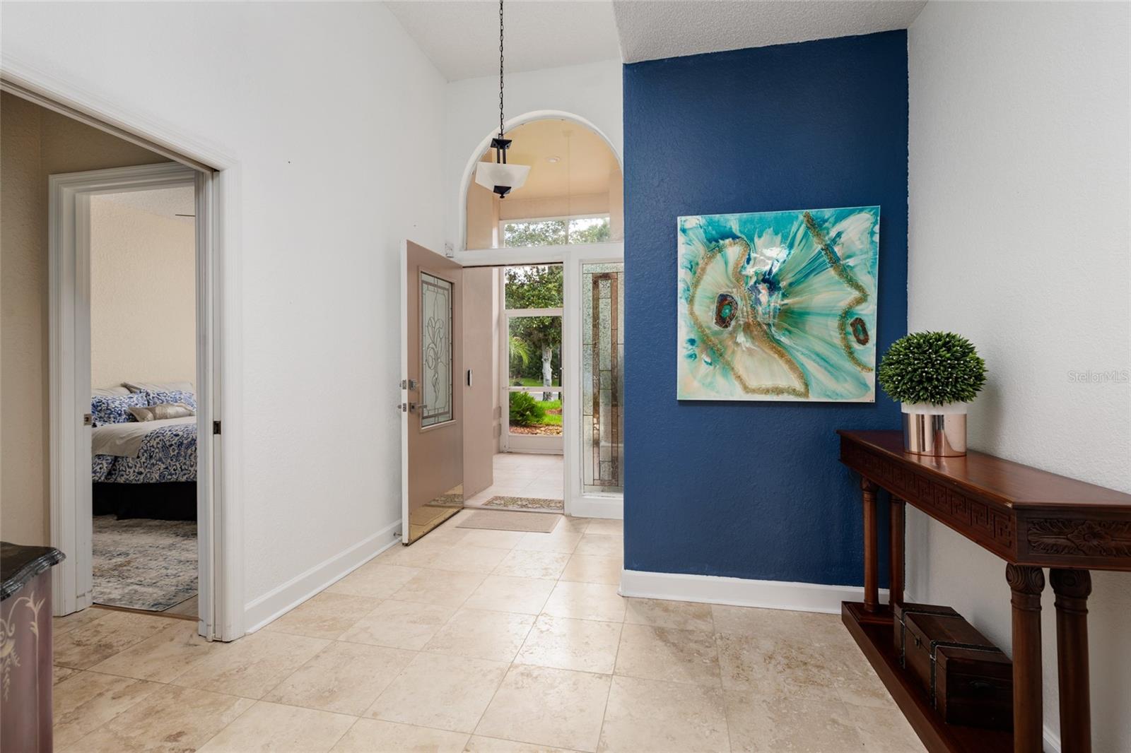 Entryway with foyer and front bedroom
