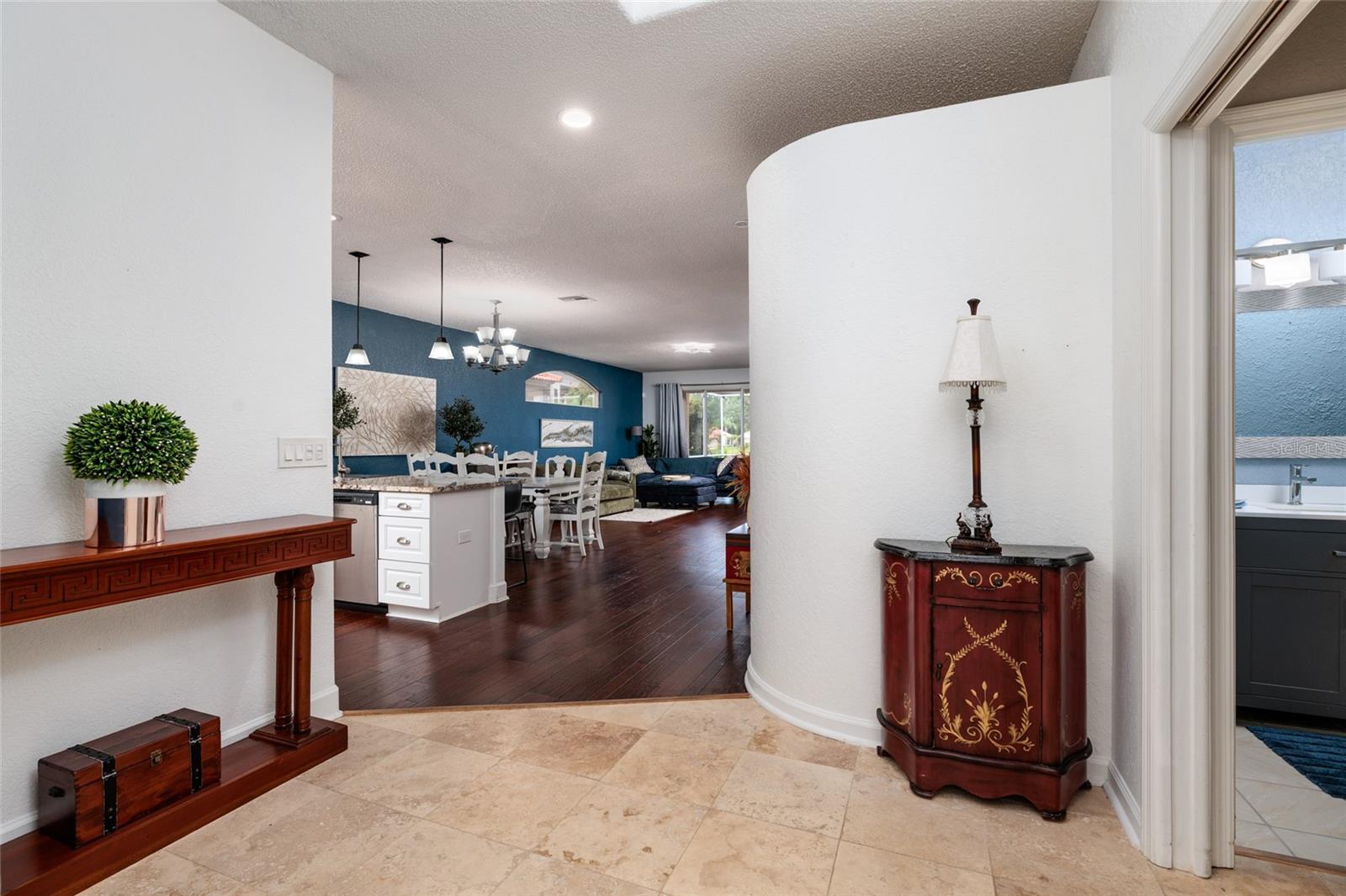 view from front door into foyer, kitchen, dinging room and living area