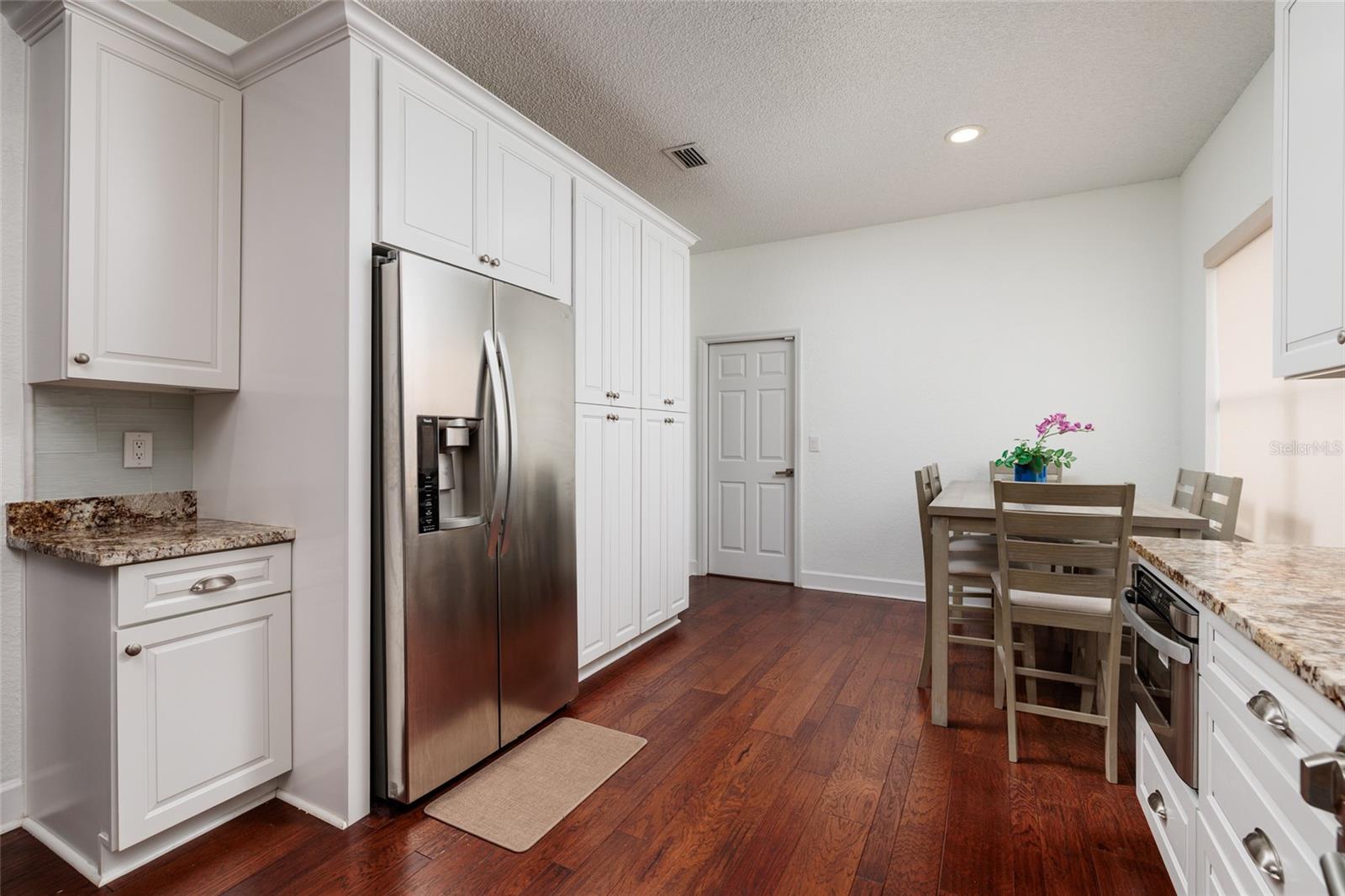 This kitchen has an abundance of cabinets.  The kitchen leads to the garage.