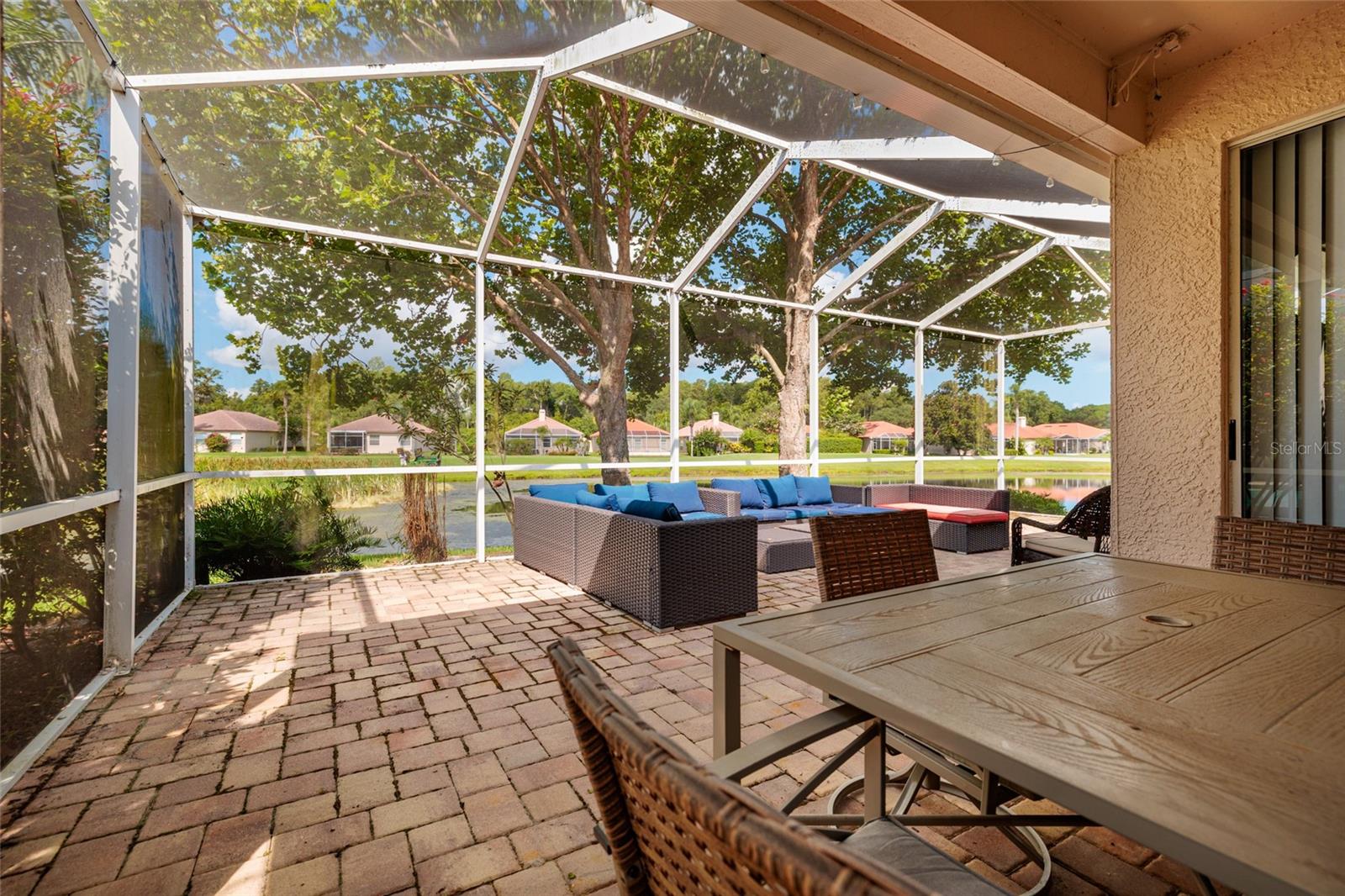 This large lanai overlooks the pond, perfect for entertaining and enjoying your time outside.