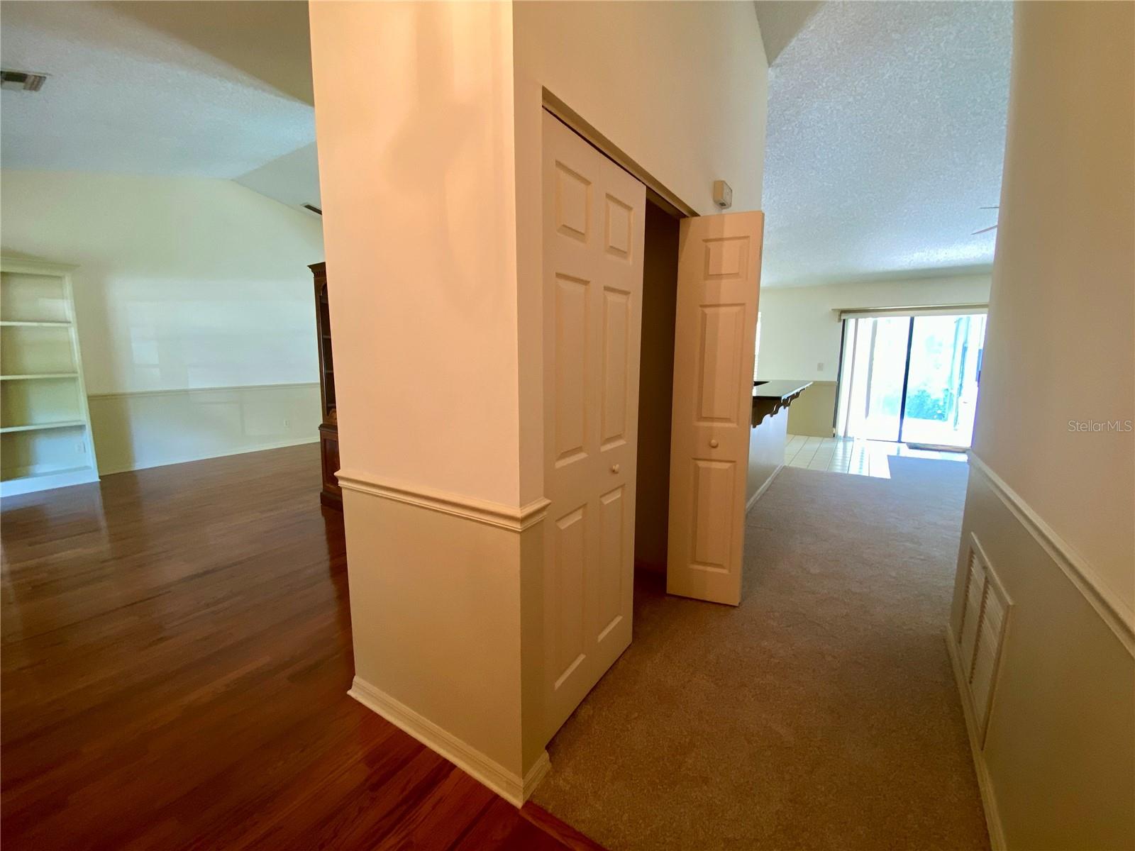 View entering. Living room on left, coat closet and family room straight ahead