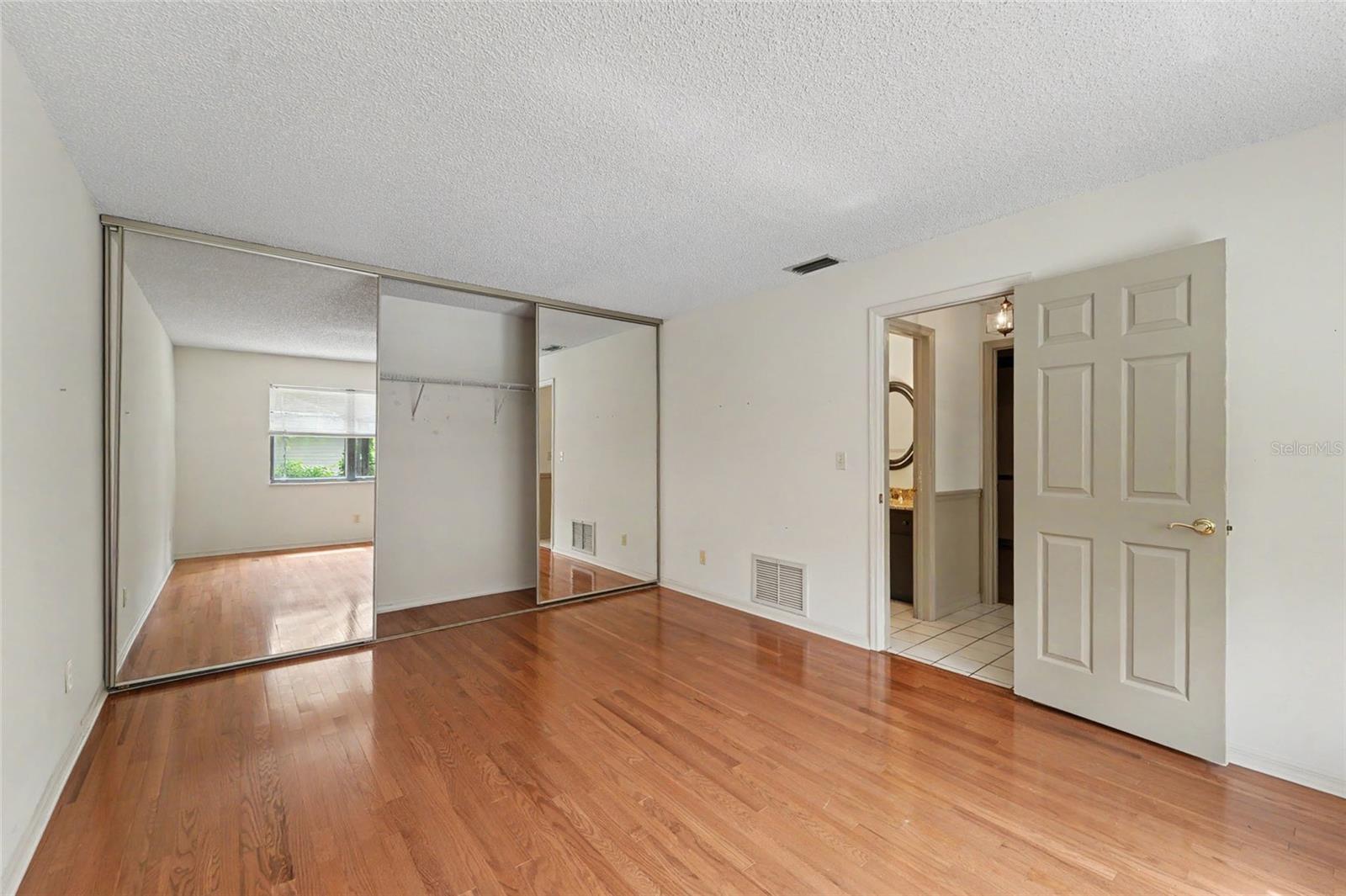 2nd bedroom with mirrored closets, pool view
