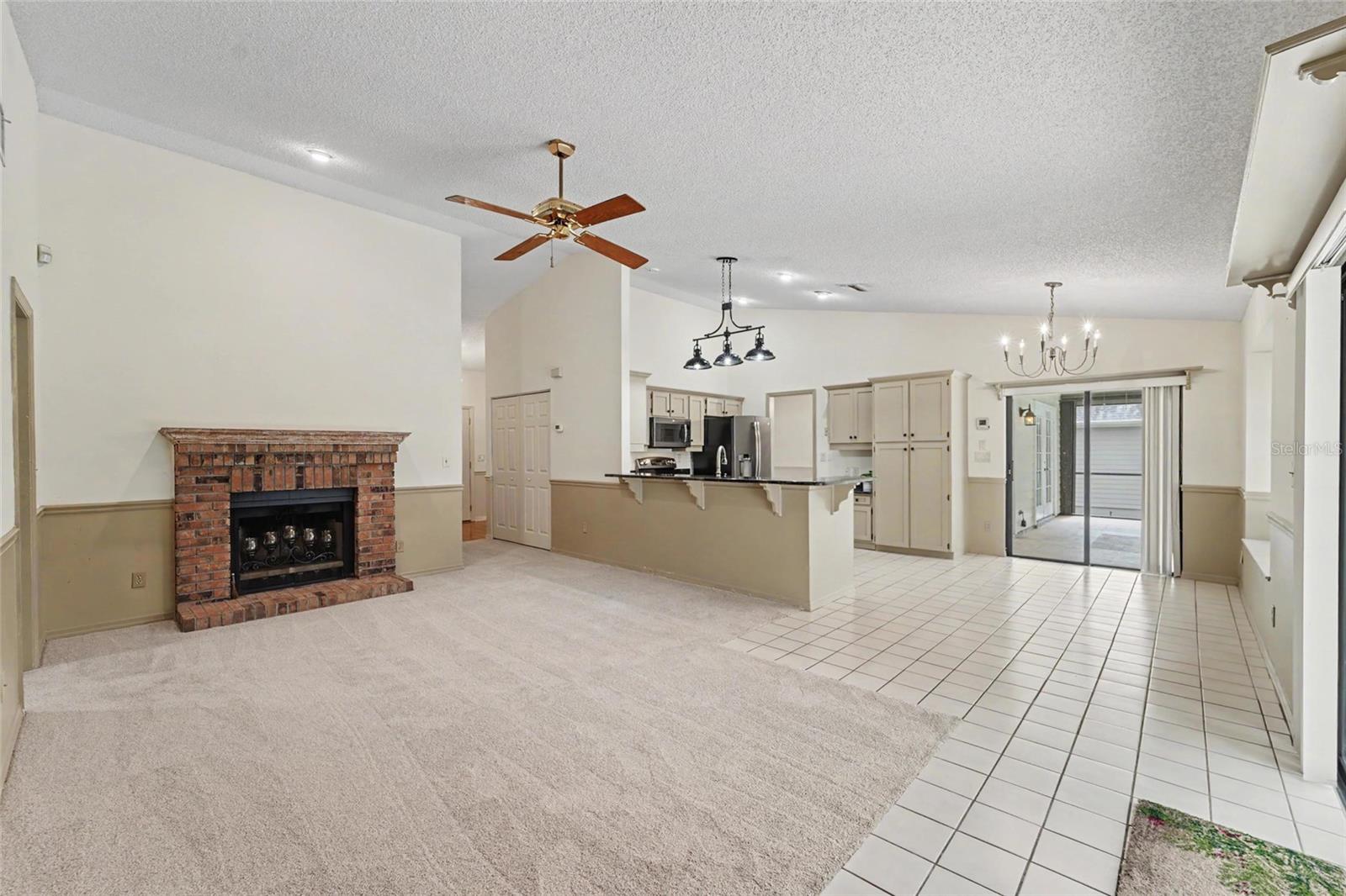 Family room, vaulted ceilings, fireplace open to kitchen
