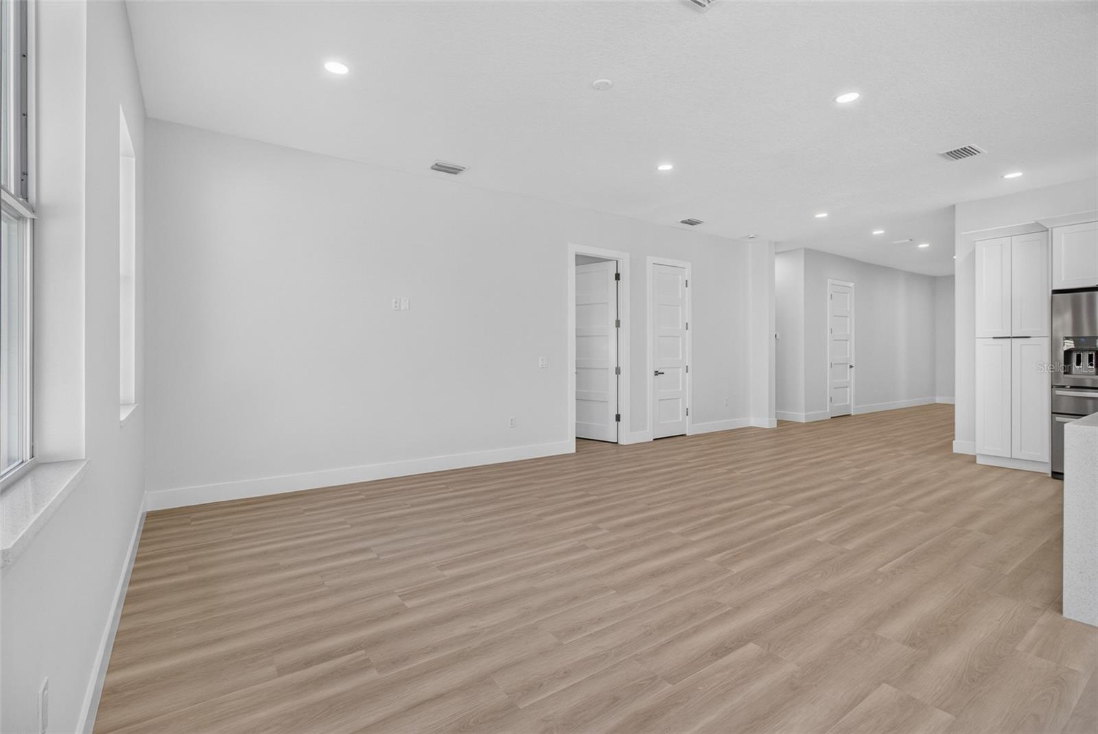 Great Room with Primary Bedroom thru open door