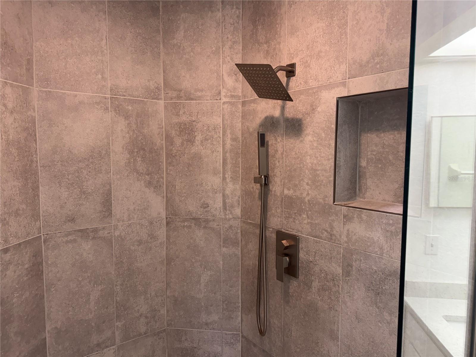 Upgraded tile and shower enclosure.
