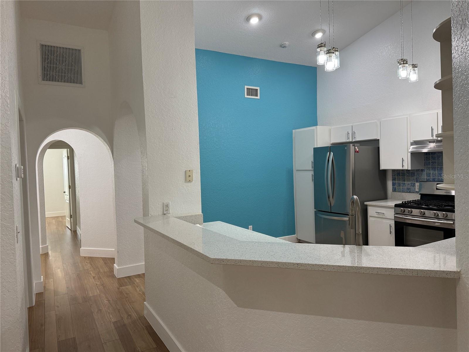 View from living room to kitchen and entry arches.